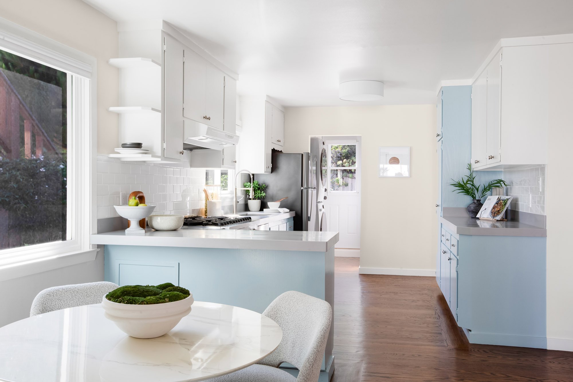 Recently updated eat-in kitchen at 465 30th Street with a breakfast peninsula, subway tile, gas range and stainless refrigerator, with laundry beside the rear garden door