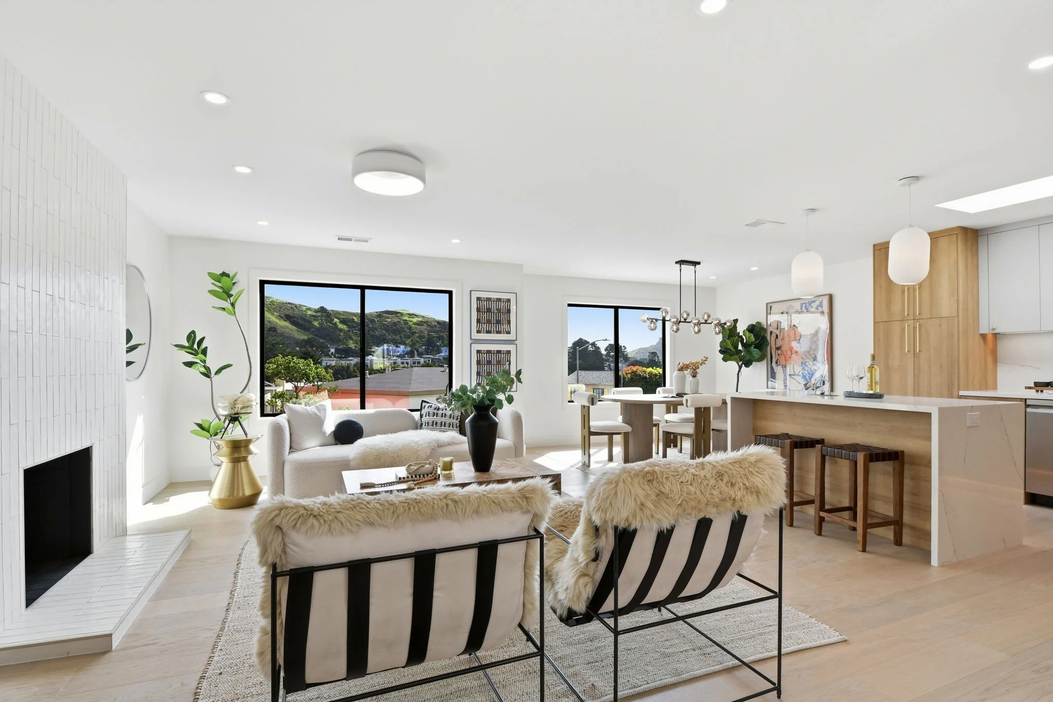 Expansive great room combining living and dining areas with panoramic views of the San Francisco hills from a Midtown Terrace luxury property.