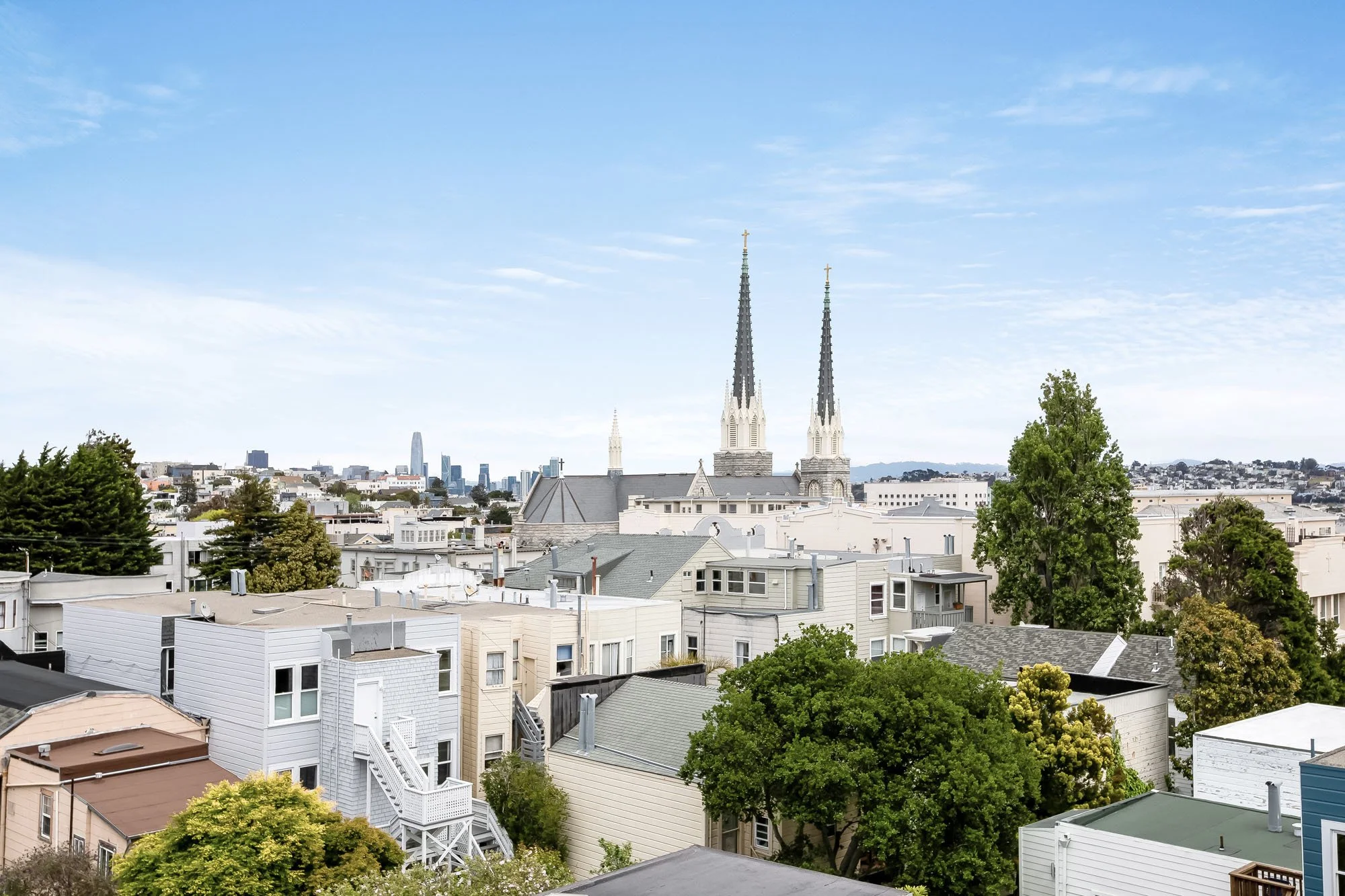 Panoramic San Francisco views from 1647 Sanchez, showcasing the Mission Dolores steeples, the Salesforce Tower, and the downtown skyline.