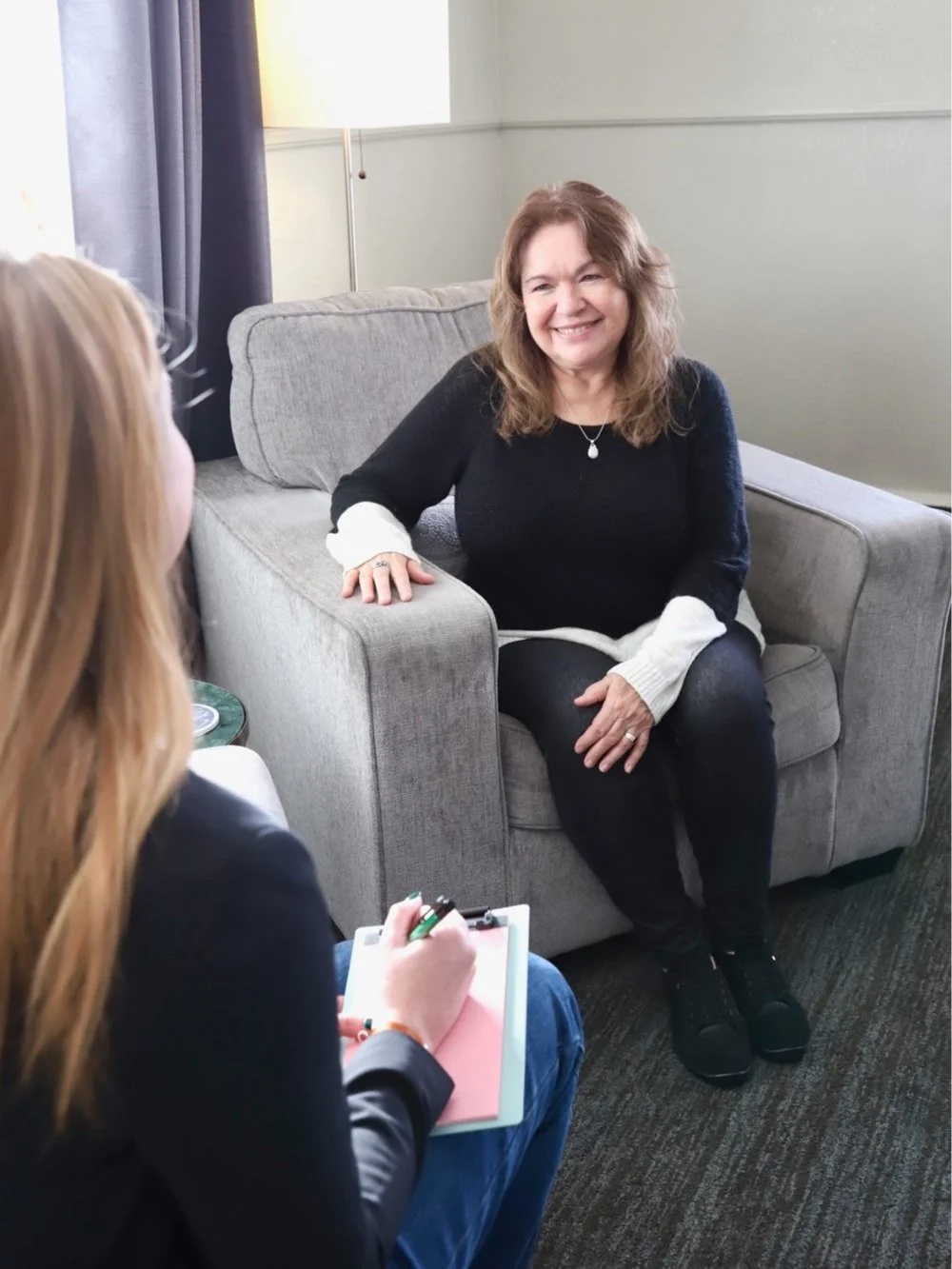 Therapist engaging with a client in a comfortable setting, representing personalized individual therapy services in Denver & Littleton, CO
