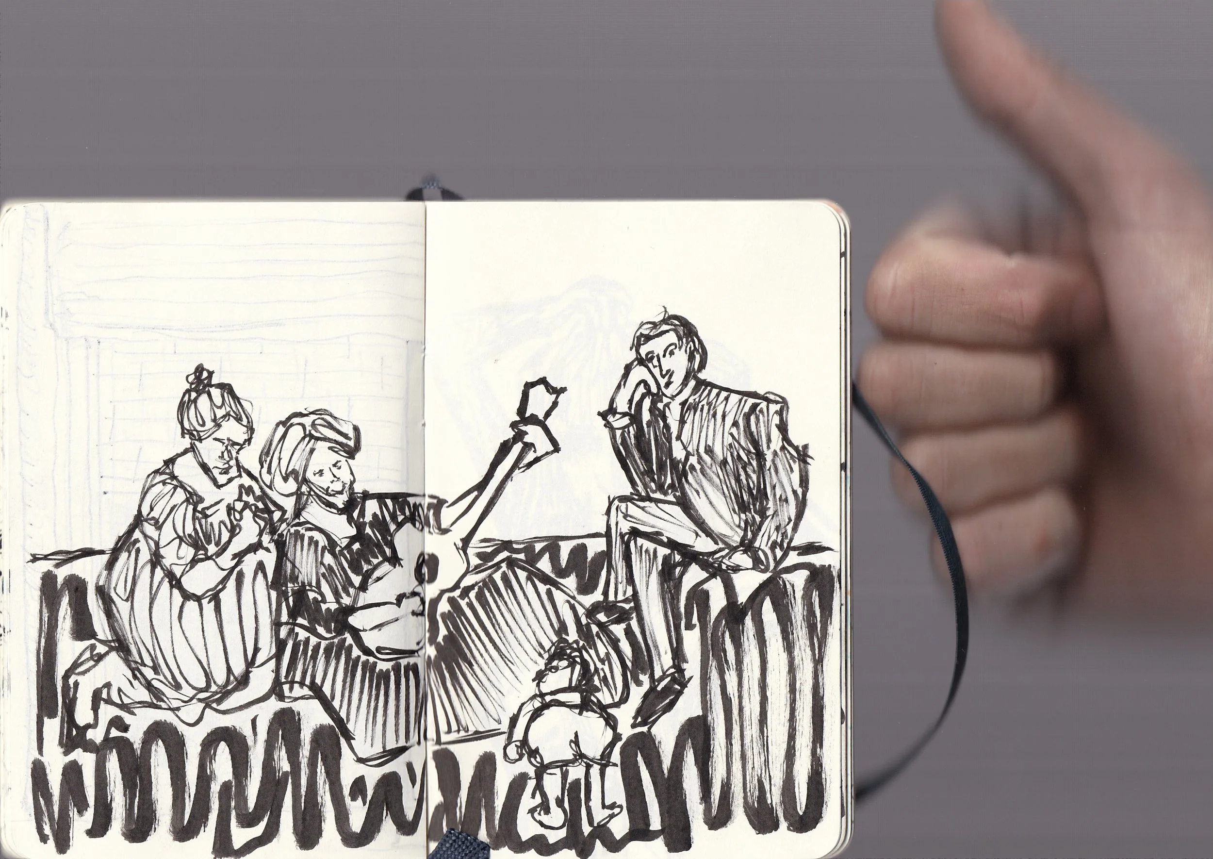 A hand pointing at a sketchbook open to a drawing of four people sitting and chatting, with some text at the bottom.