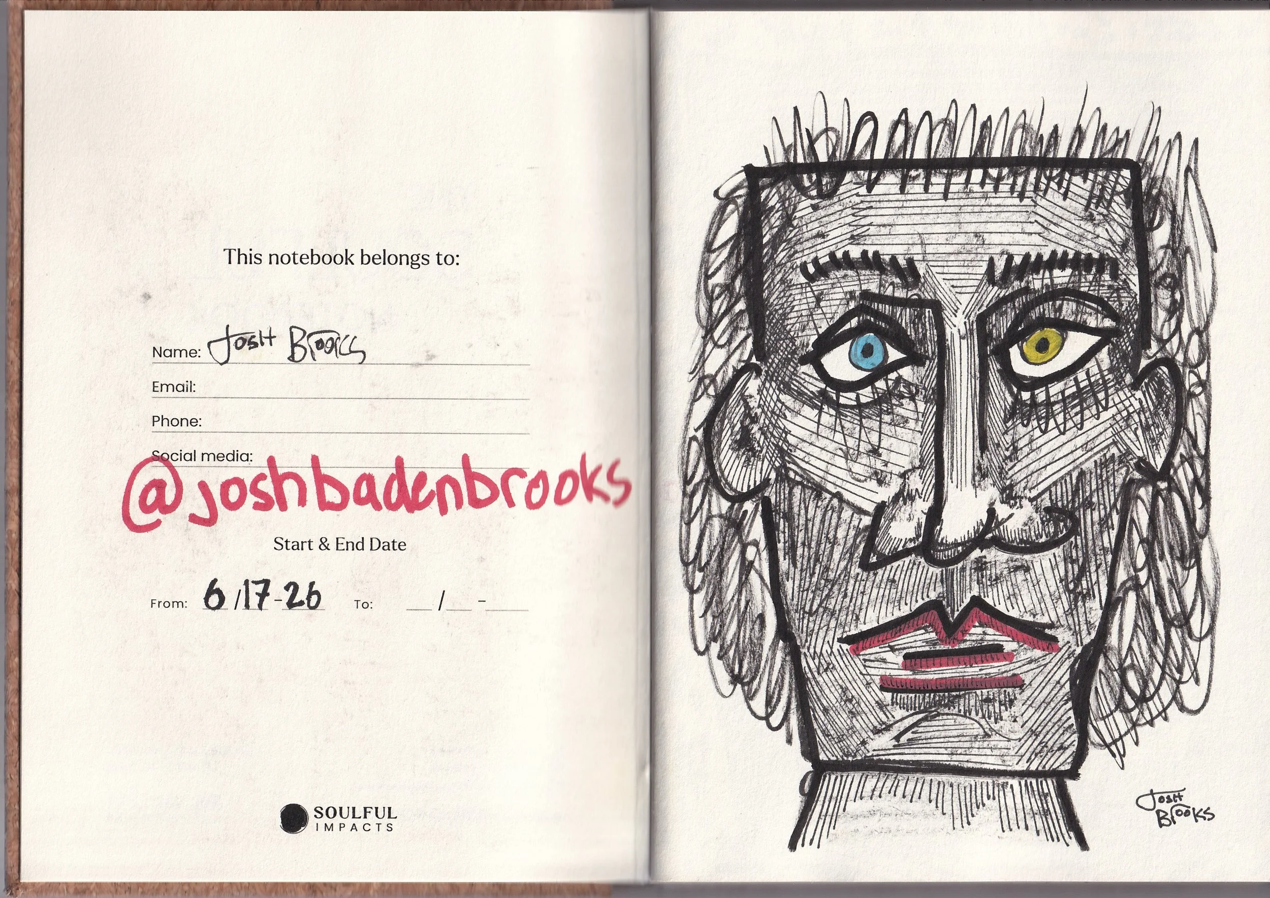 An open notebook showing a handwritten name, email, phone number, and social media handle on the left page. The right page contains a detailed, artistic black ink sketch of a person's face with heterochromatic eyes—one blue and one yellow—wearing a c