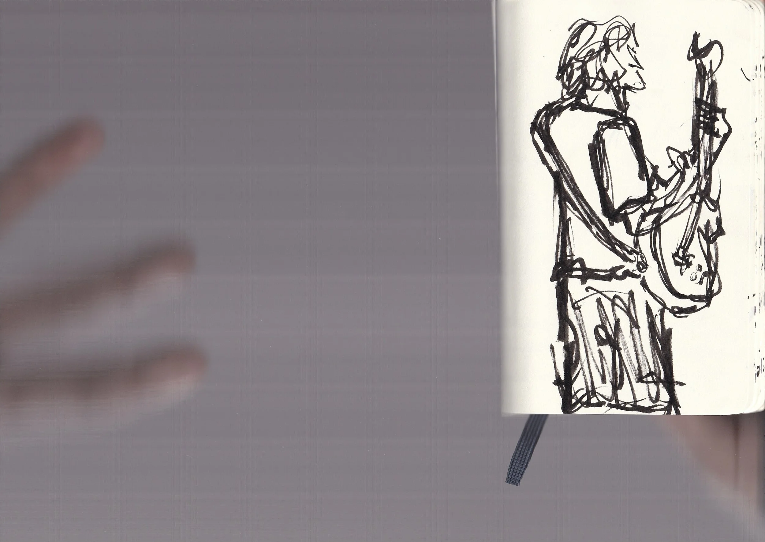 Black ink sketch of two people standing closely, drawn on a page in a notebook.