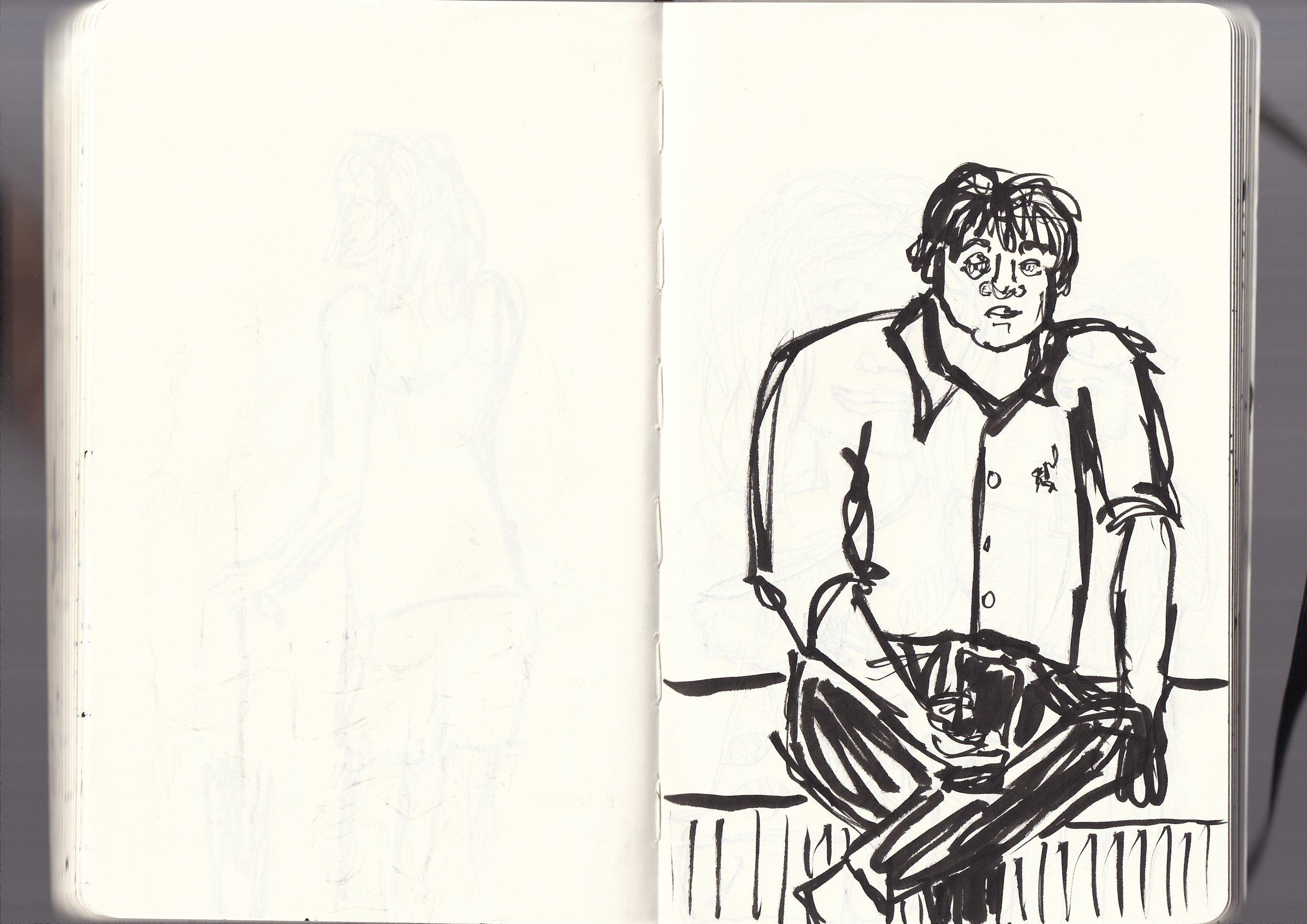 A black ink sketch of a young man with messy hair, sitting on a bench or chair, wearing a jacket and looking slightly to the right.