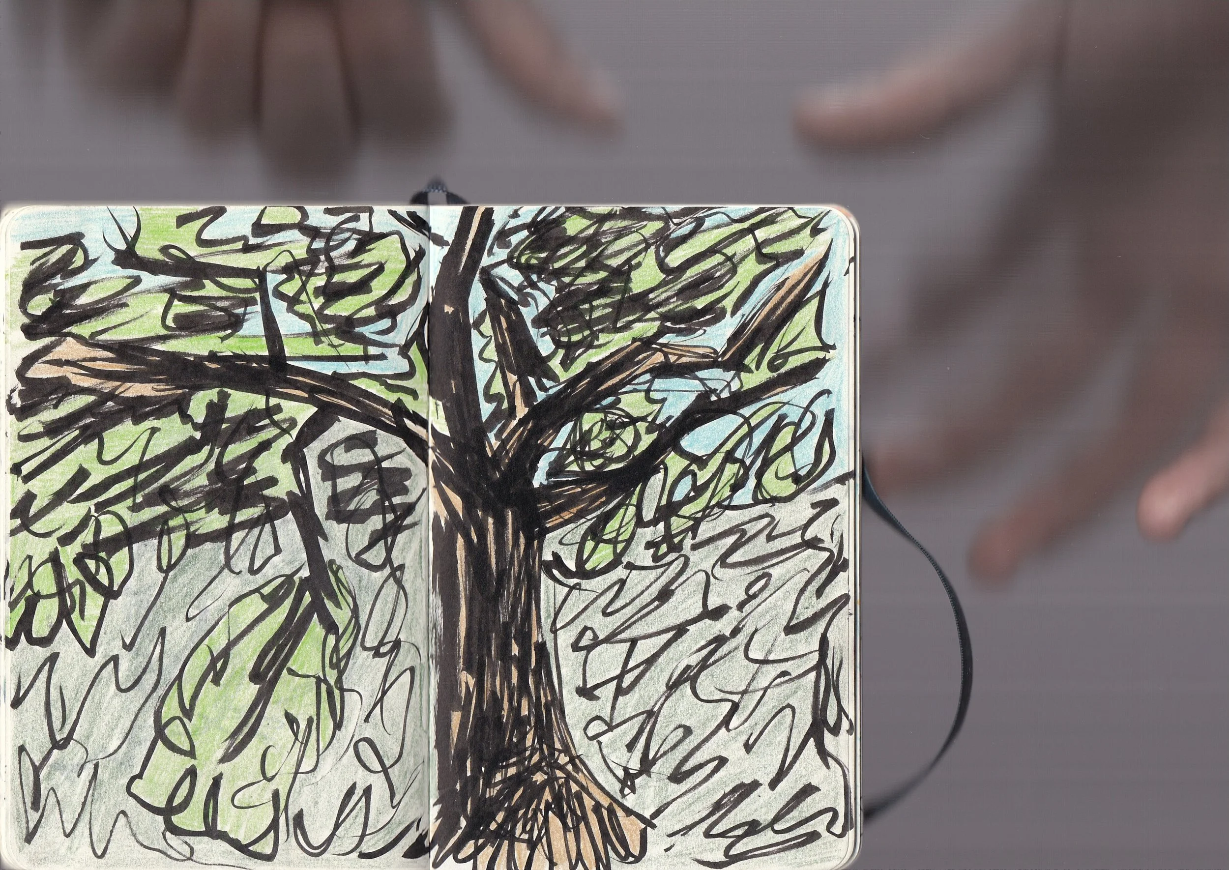 A card with a hand-drawn picture of a tree with green foliage and a brown trunk, created with black and colored markers.
