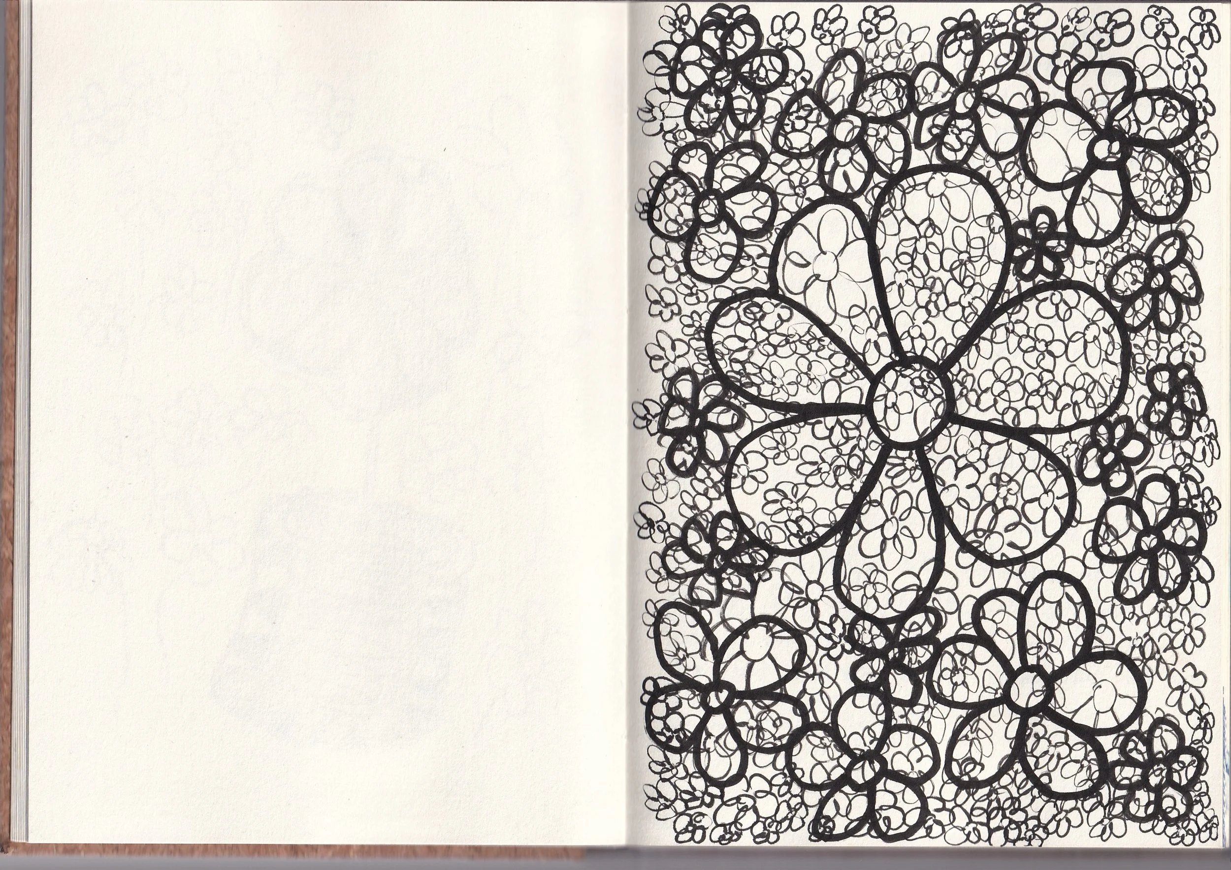 A black and white abstract drawing of a large flower with intricate, swirling petal patterns, occupying the right page, with the left page blank.