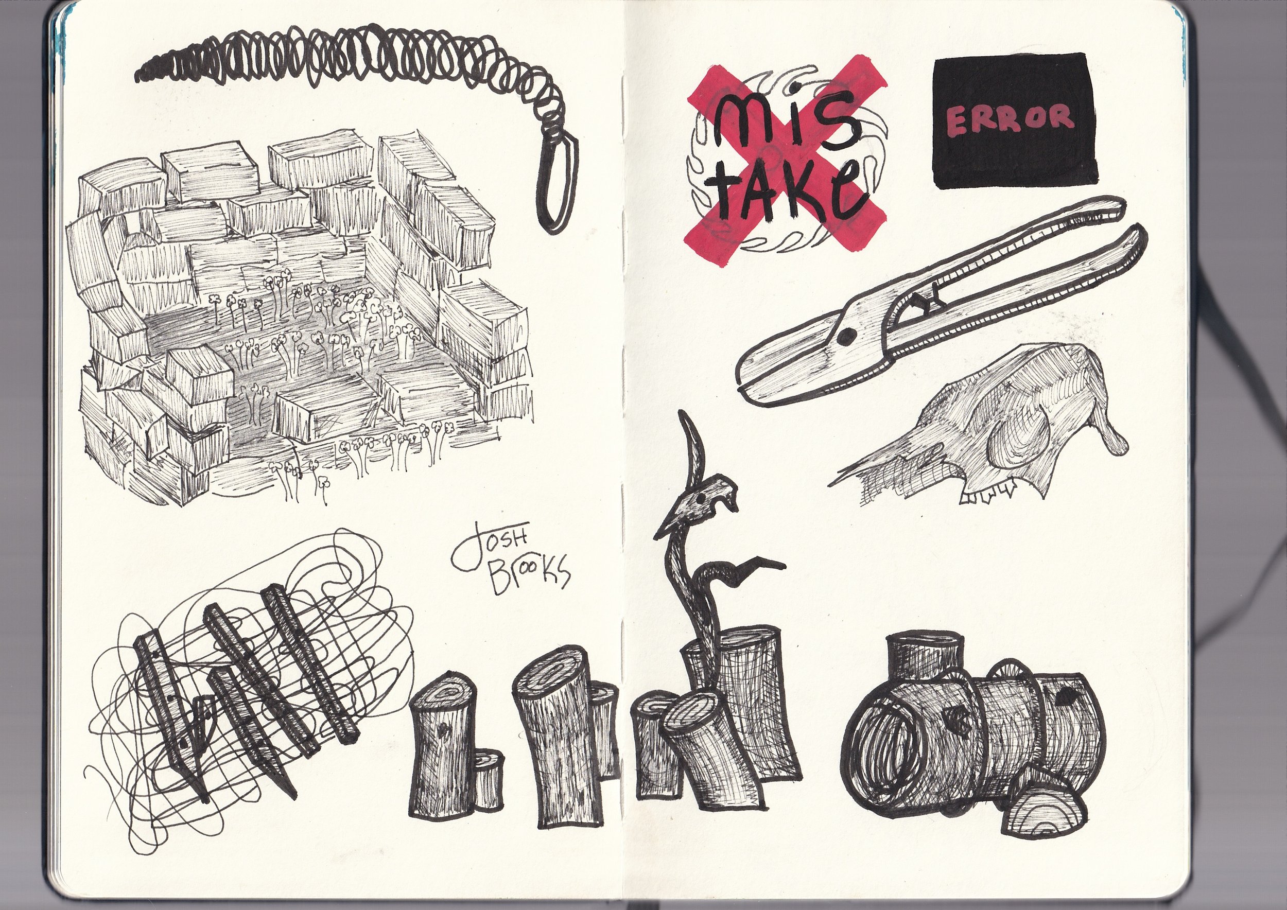 A sketchbook with various drawings and notes. On the left page, there is a detailed drawing of a paperclip, a pile of logs, some tree stumps, and the words 'Osh Books'. On the right page, there are multiple drawings including a torn skull, logs, and 