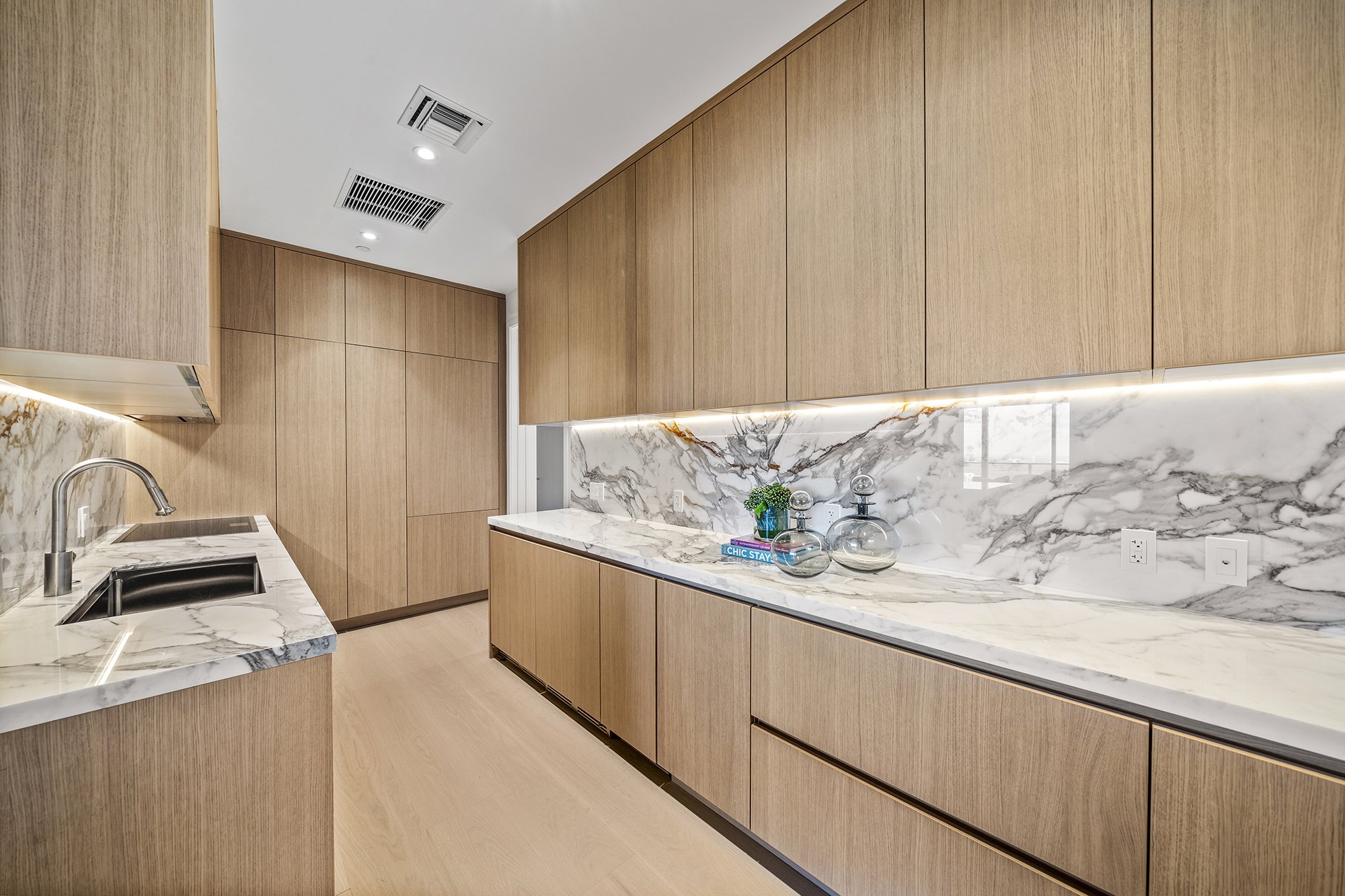 Modern kitchen with wood cabinets and marble countertops