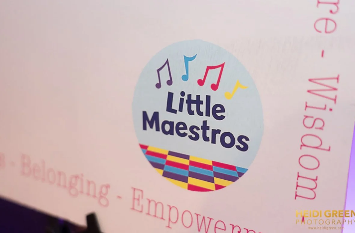 Logo for Little Maestros, featuring colorful musical notes and a vibrant, checkered stage design.
