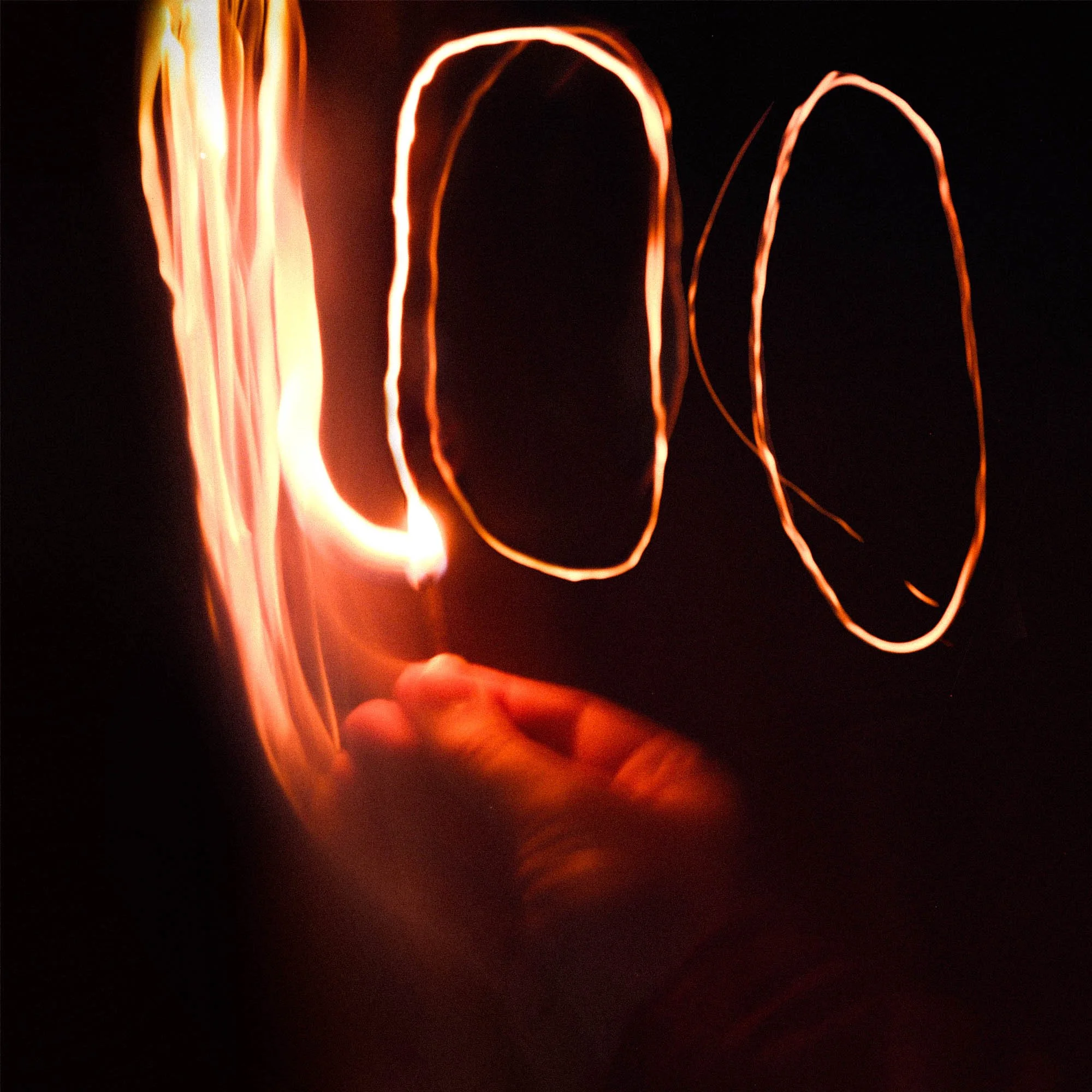 Close-up of glowing red-orange neon light streaks against a dark background.