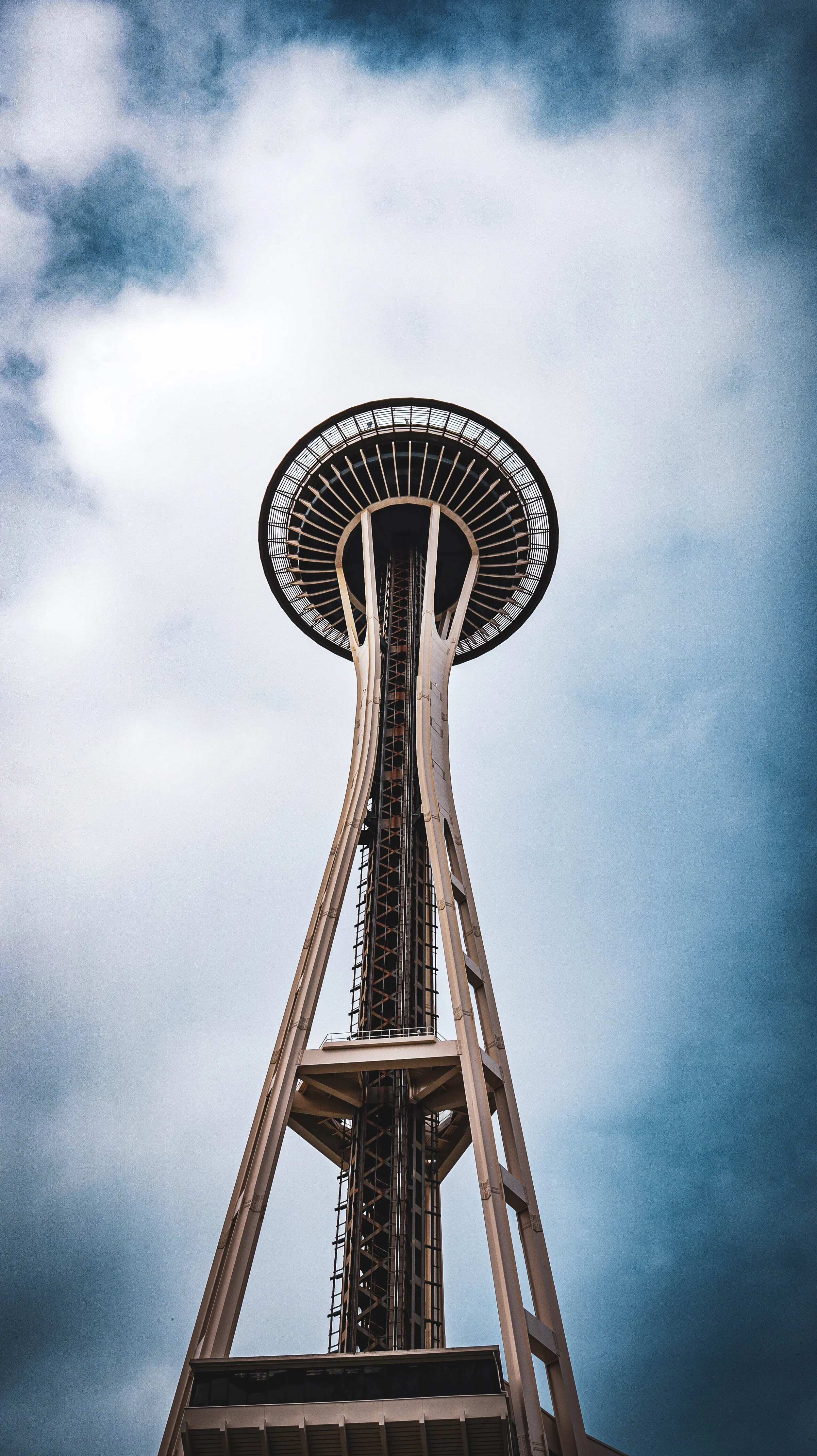Seattle Space Needle, set against a cloudy sky.