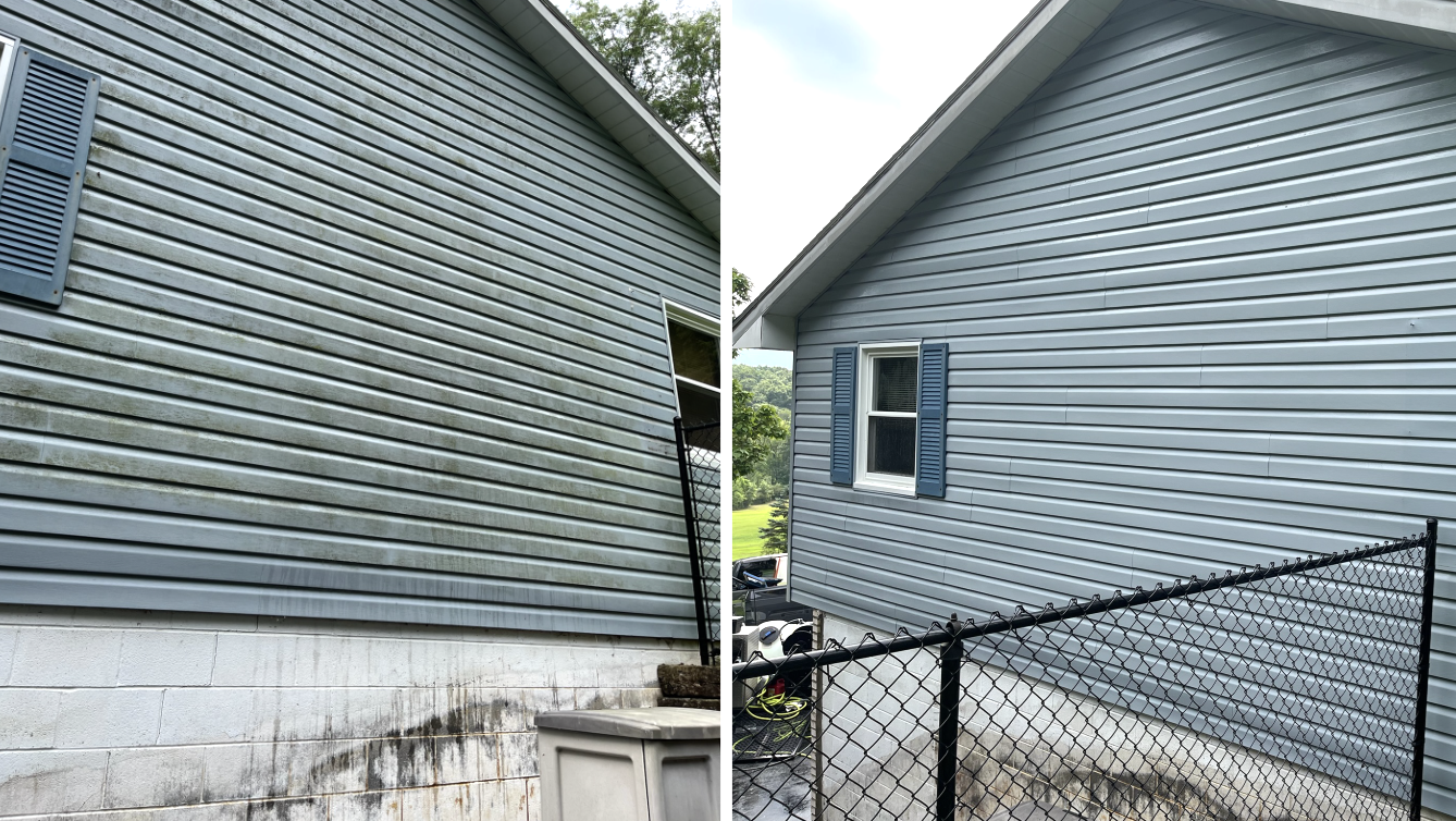 Side-by-side images of a blue house exterior before and after cleaning. The left shows dirt and stains on the siding, while the right shows clean siding with a black chain-link fence in front.