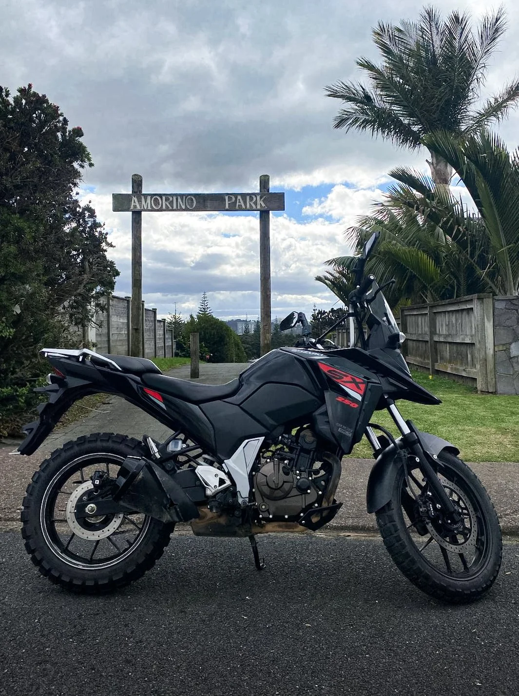 Motorcycle parked near a beach with ocean view