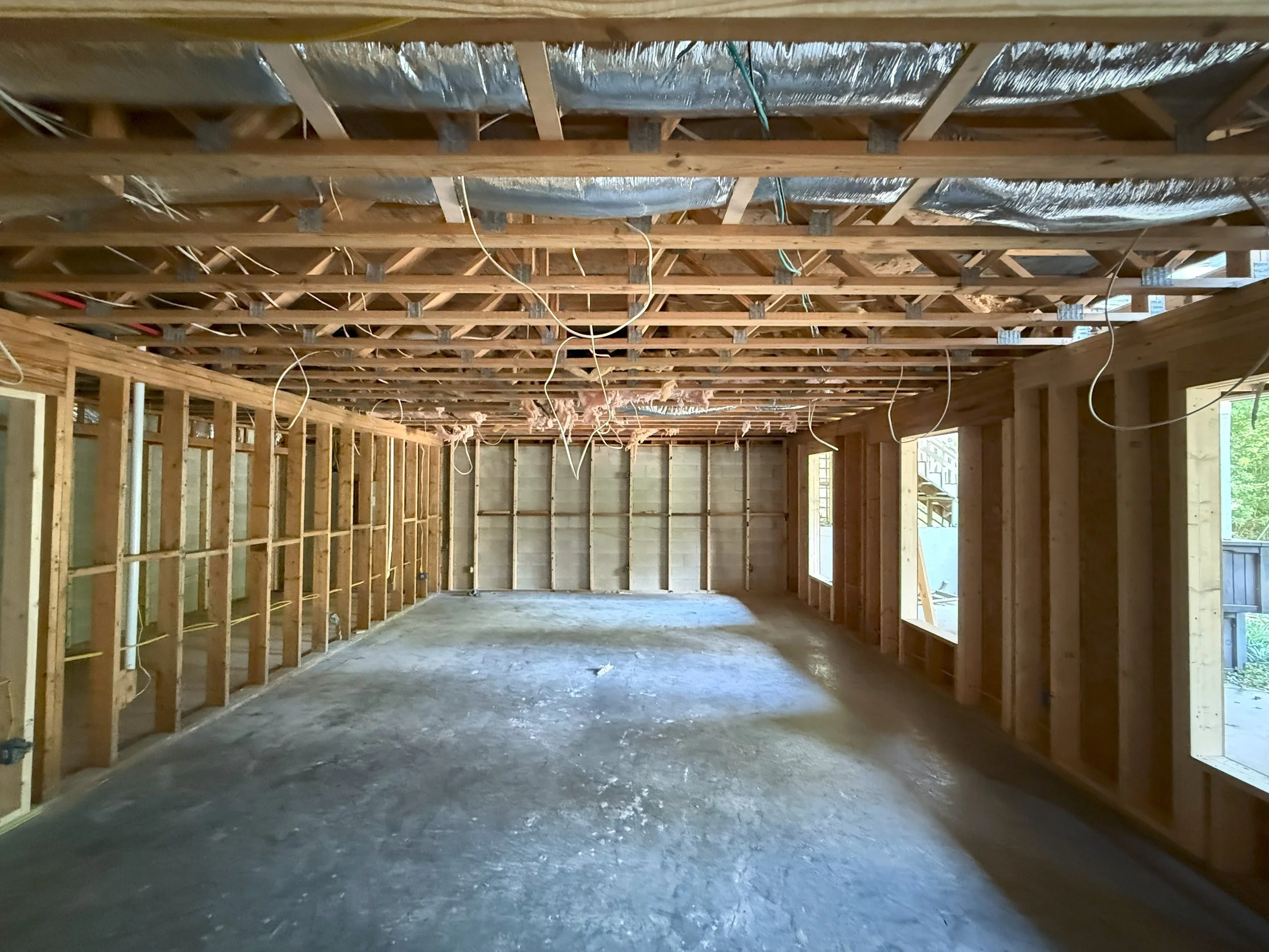 A room with no dry wall showing the electrical wire thoughtfully installed in the room