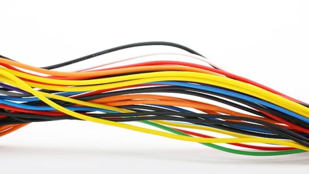 Colorful wires tangled together on a white background