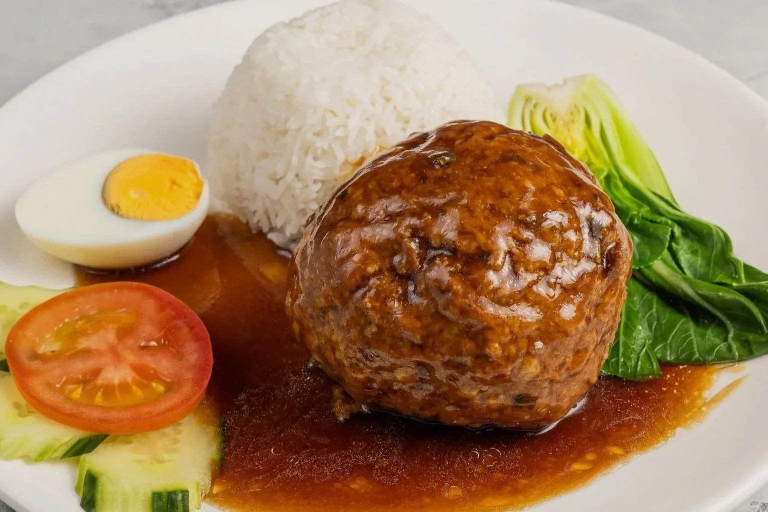Lions' Head Meat Ball (giant meat ball) with rice and pak choi.