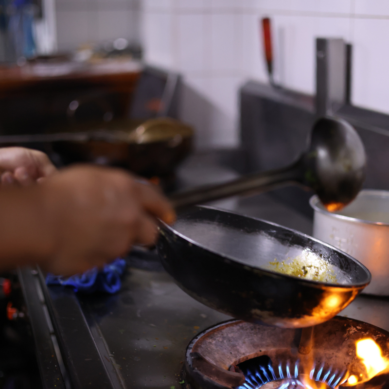 a chef cooking stir fries in a wok