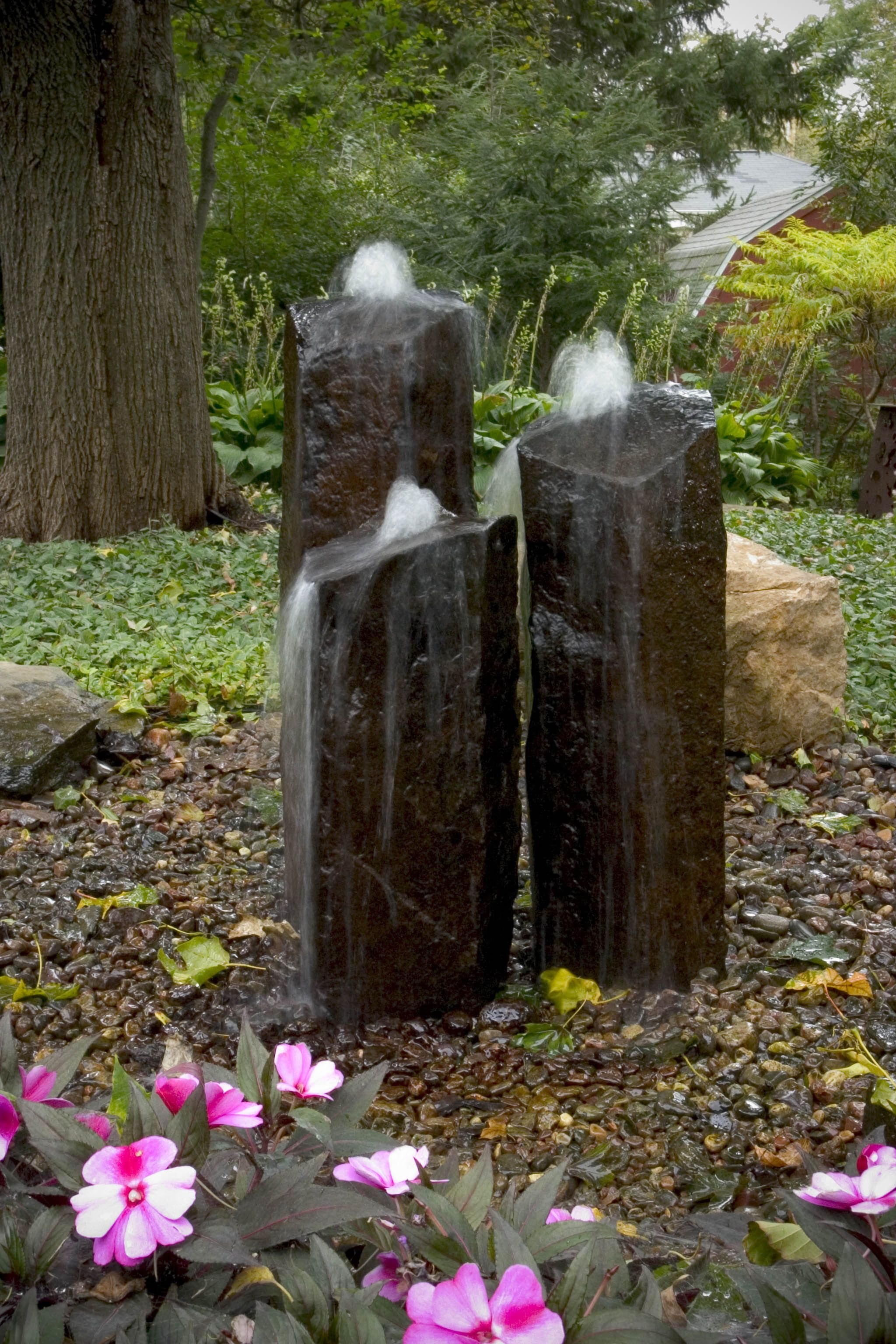 Garden with water feature and pink flowers