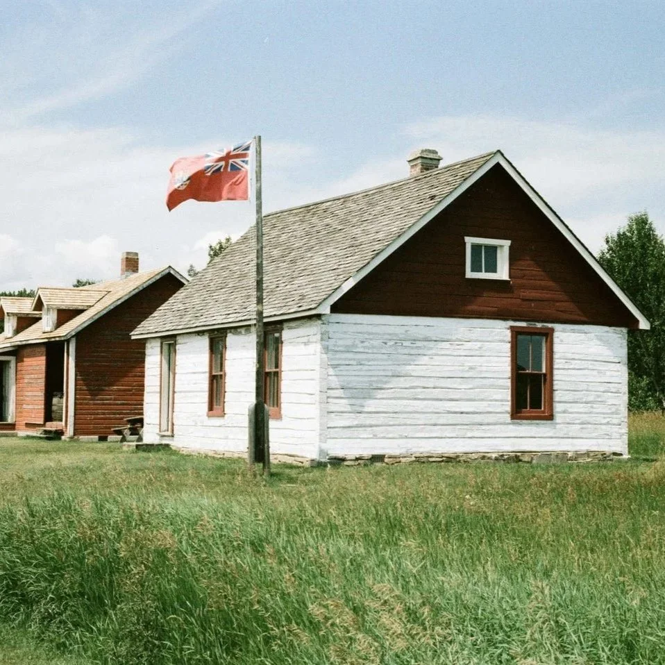 historic-red-and-white-house-with-british-flag-in-grassy-surroundings.jpg