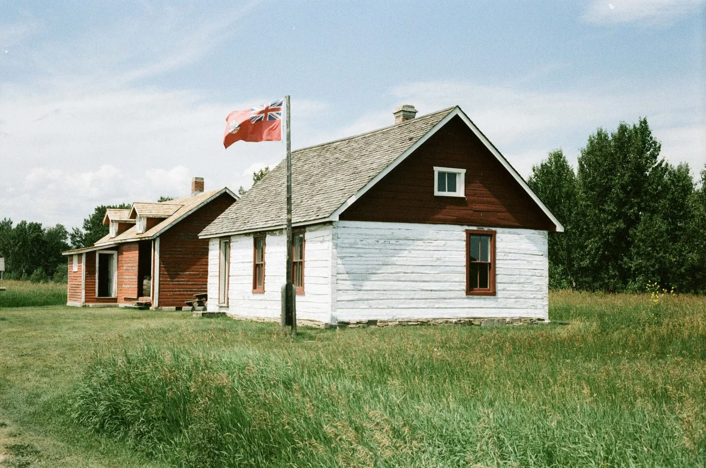 historic-red-and-white-house-with-british-flag-in-grassy-surroundings.jpg