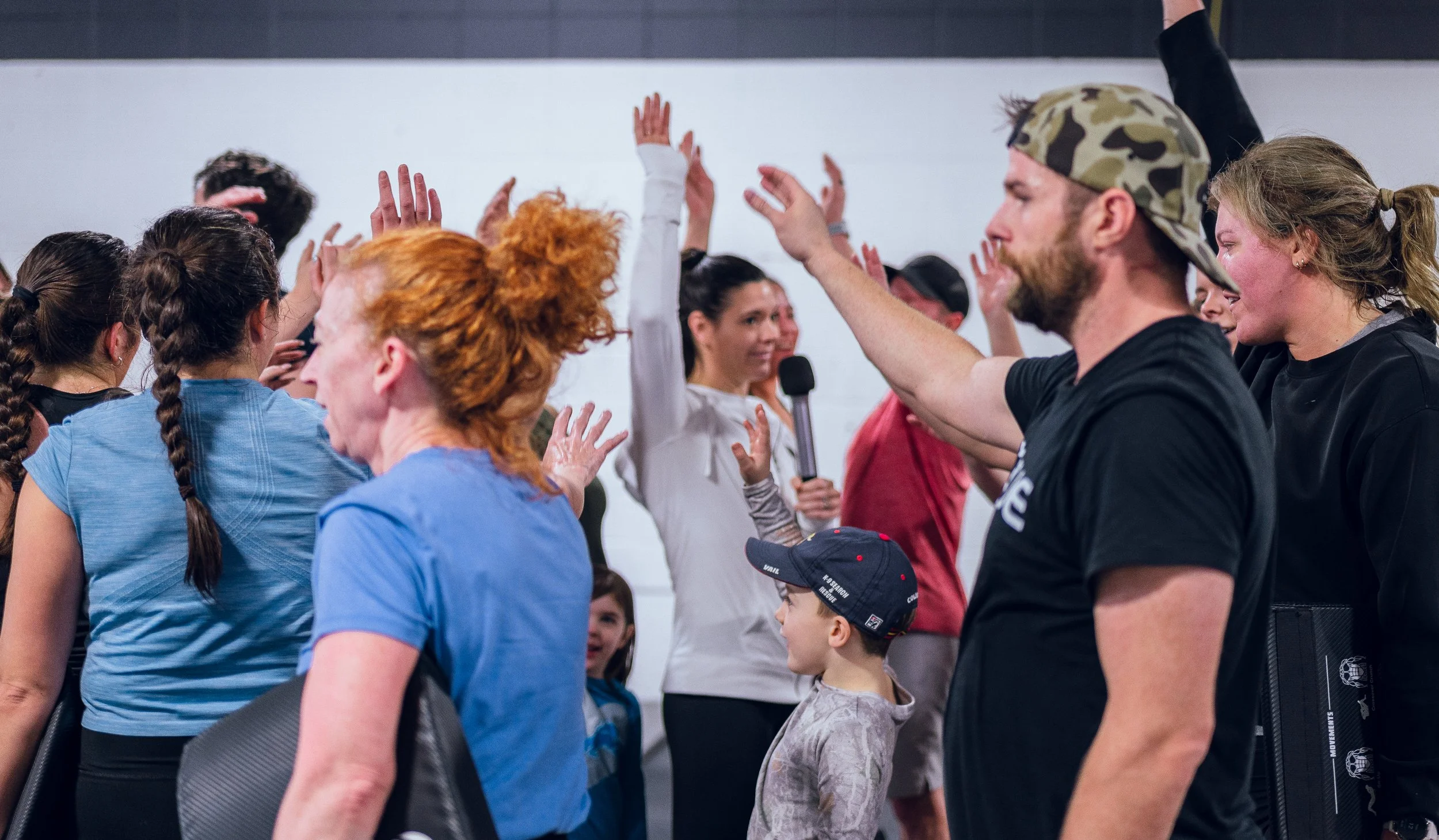 Members high-fiving after a workout
