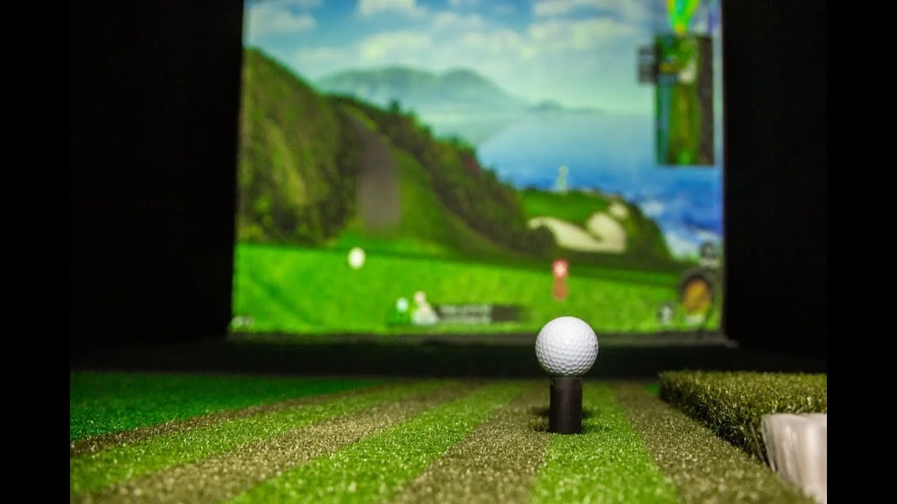 Golf ball on tee at an indoor virtual golf simulator.