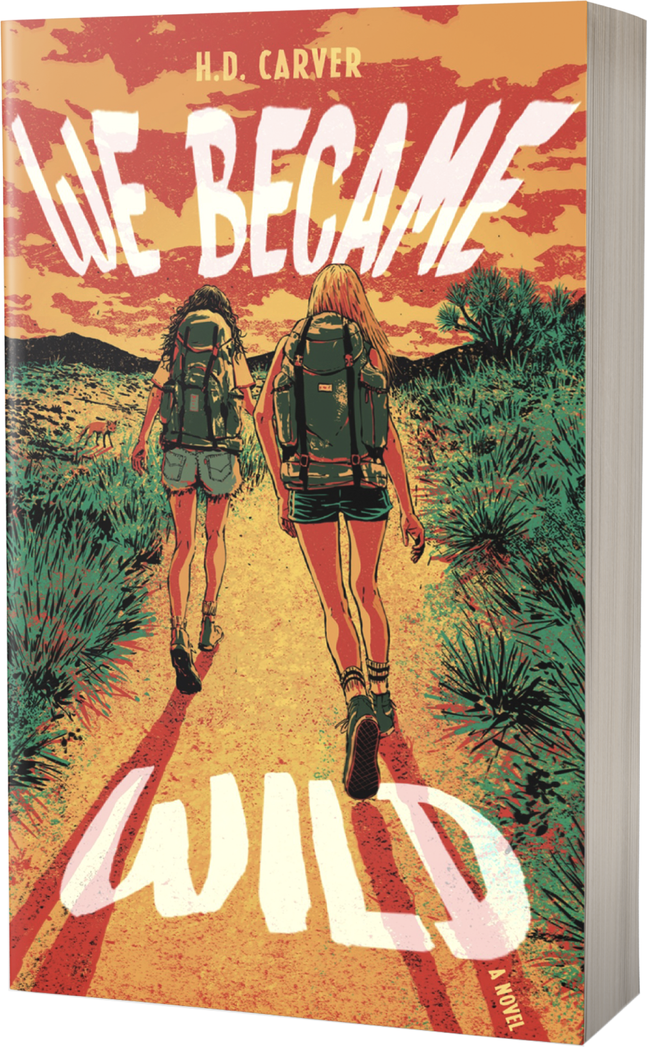 Book cover for "We Become Wild" by H.D. Carver. The cover features an illustration of two women with backpacks hiking on a dirt trail in a desert-like landscape with low vegetation, under a dramatic sky with orange, pink, and purple clouds. The title is written in large white text across the top and bottom of the cover.