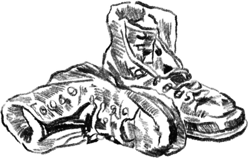 A person wearing a hoodie and jacket is sitting on the ground with a camera, a notebook, and a smartphone nearby.