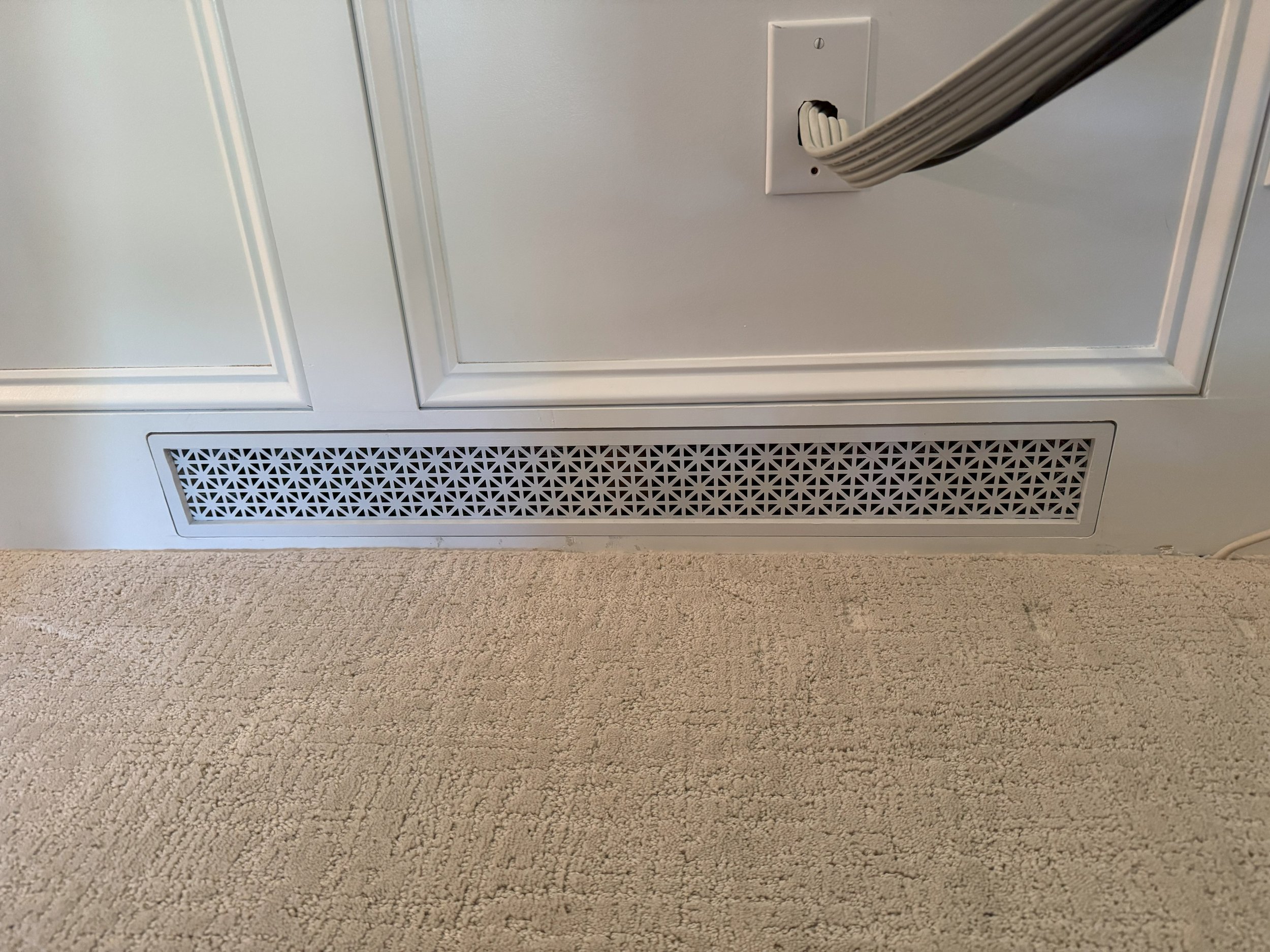 Custom removable HVAC register built into the base of wainscoting