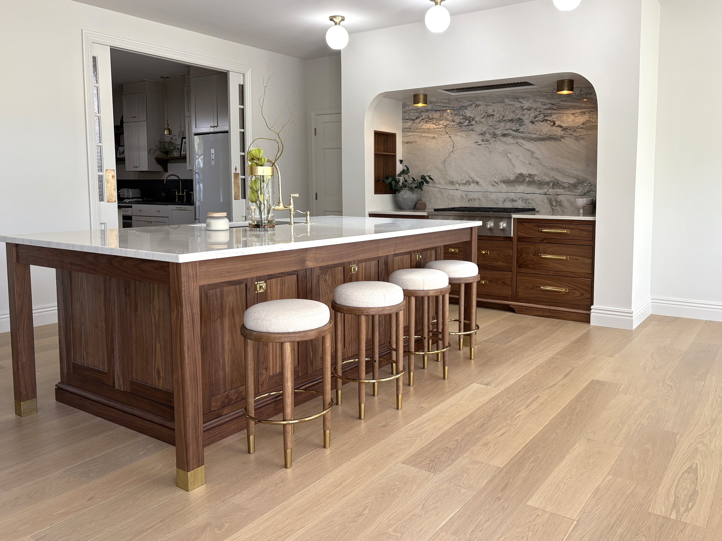 Inset walnut kitchen cabinets with a modern style and open space with white oak floors.
