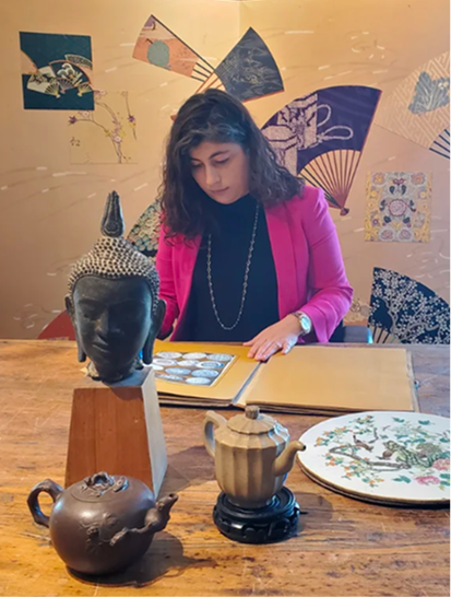 Richelle inspecting Asian Art, pictured are antiques, paintings, sculptures ready for appraisal and cataloguing.