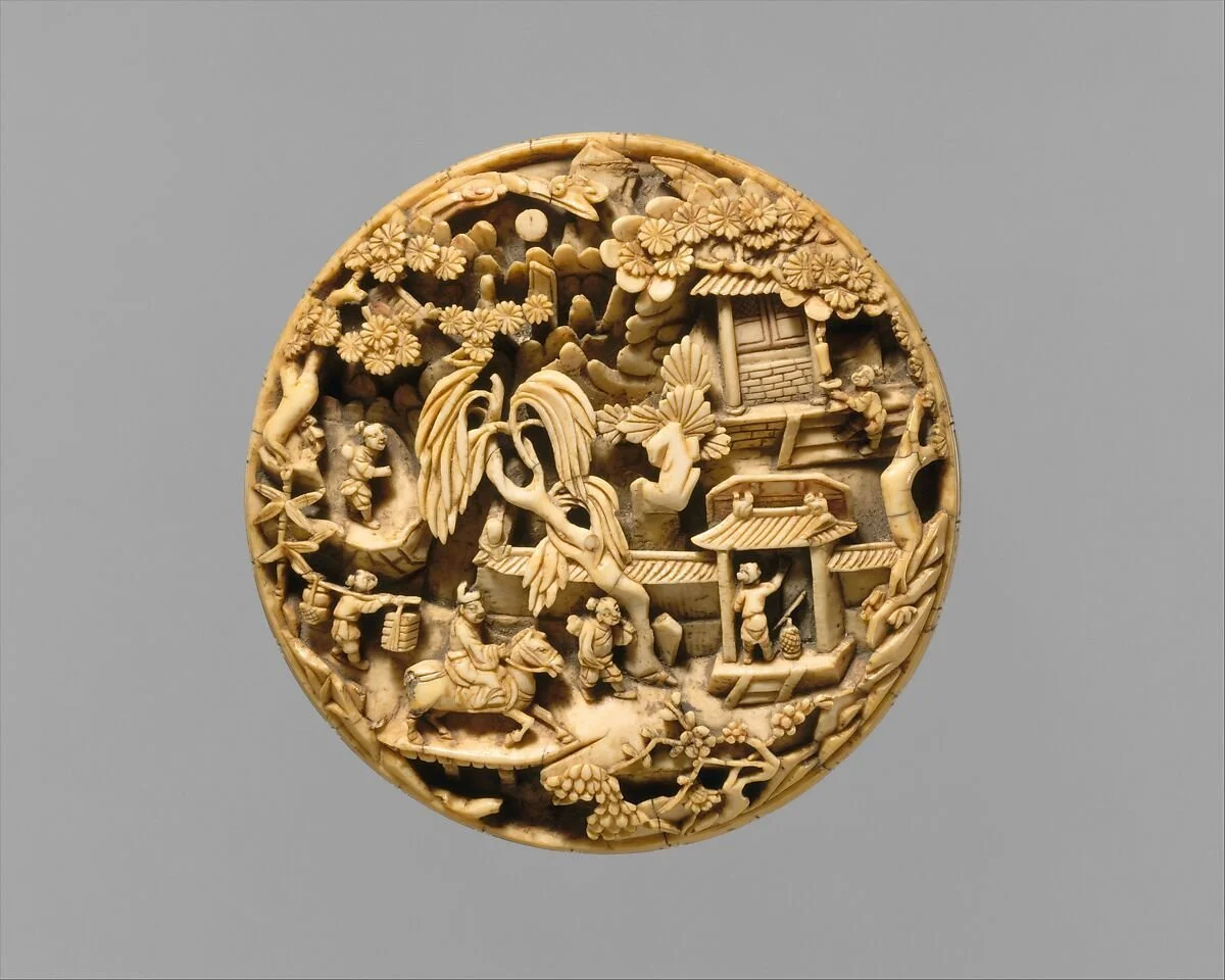 Intricate round carved ivory or bone piece depicting a traditional Asian village scene with houses, trees, people, and animals. Richelle Kokol, ISA CAPP, is an ISA Certified Appraiser of Asian Works of Art.