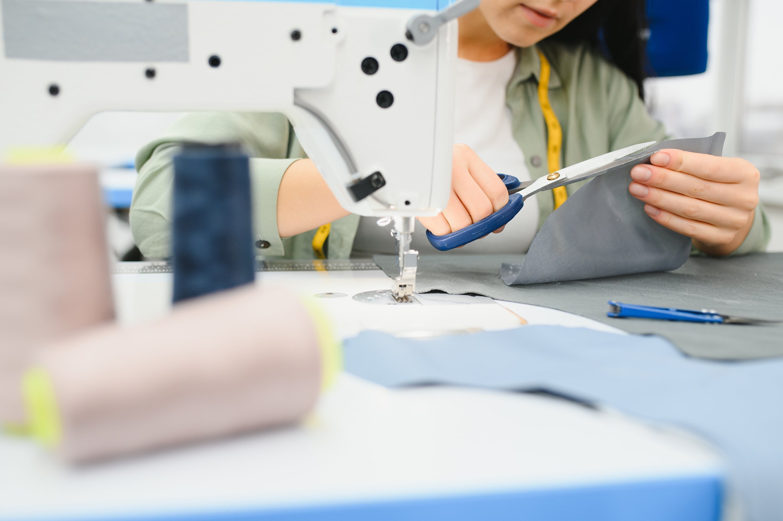 happy-attractive-young-woman-seamstress-sitting-an-2025-03-14-02-06-16-utc.jpg
