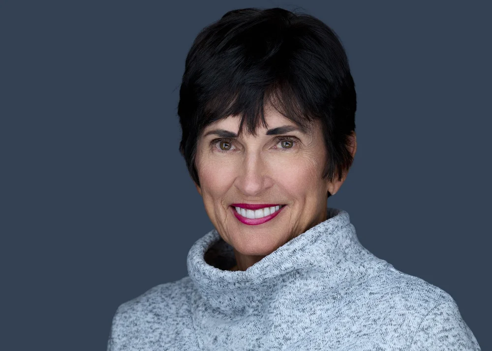 Corporate headshot of a woman in a grey turtleneck, Syracuse NY