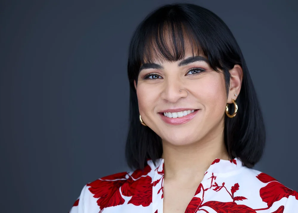 Professional headshot of a woman with gold hoop earrings, Syracuse headshot studio