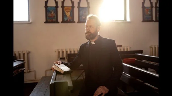 Pastor reflecting quietly in church