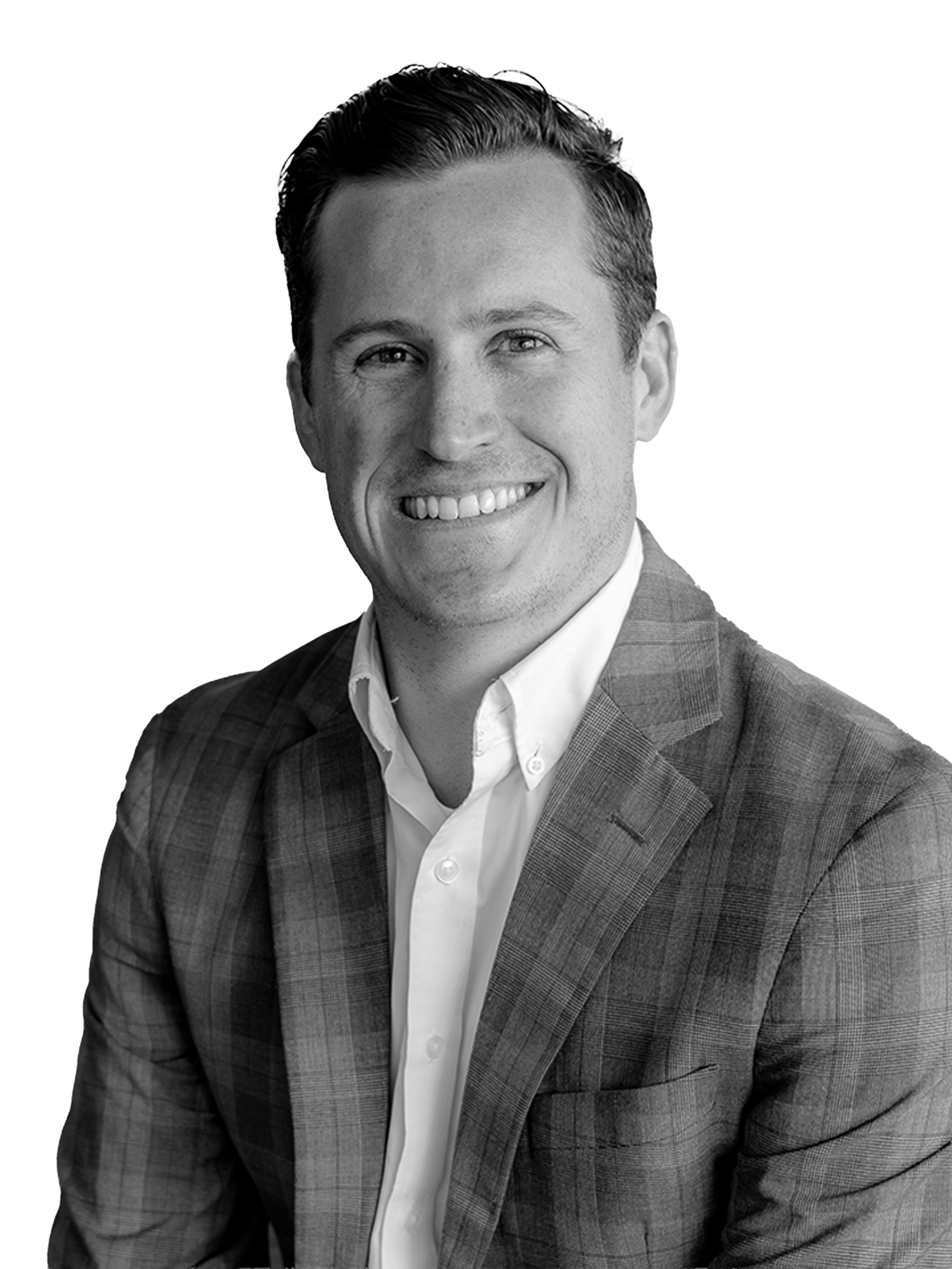 Black and white portrait of a smiling man wearing a checkered suit and white shirt.
