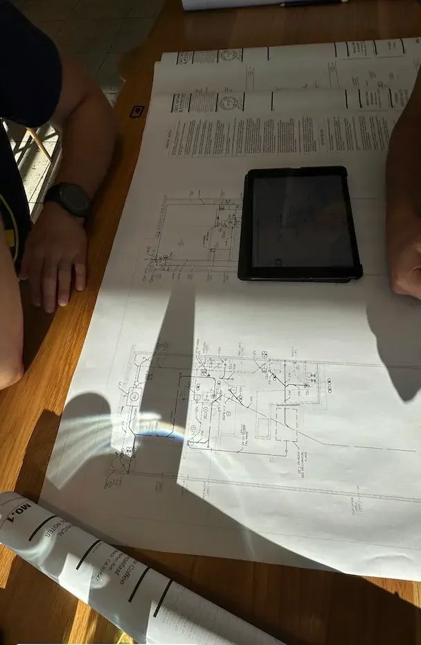 Tenant improvement architectural drawings and tablet during a client planning session
