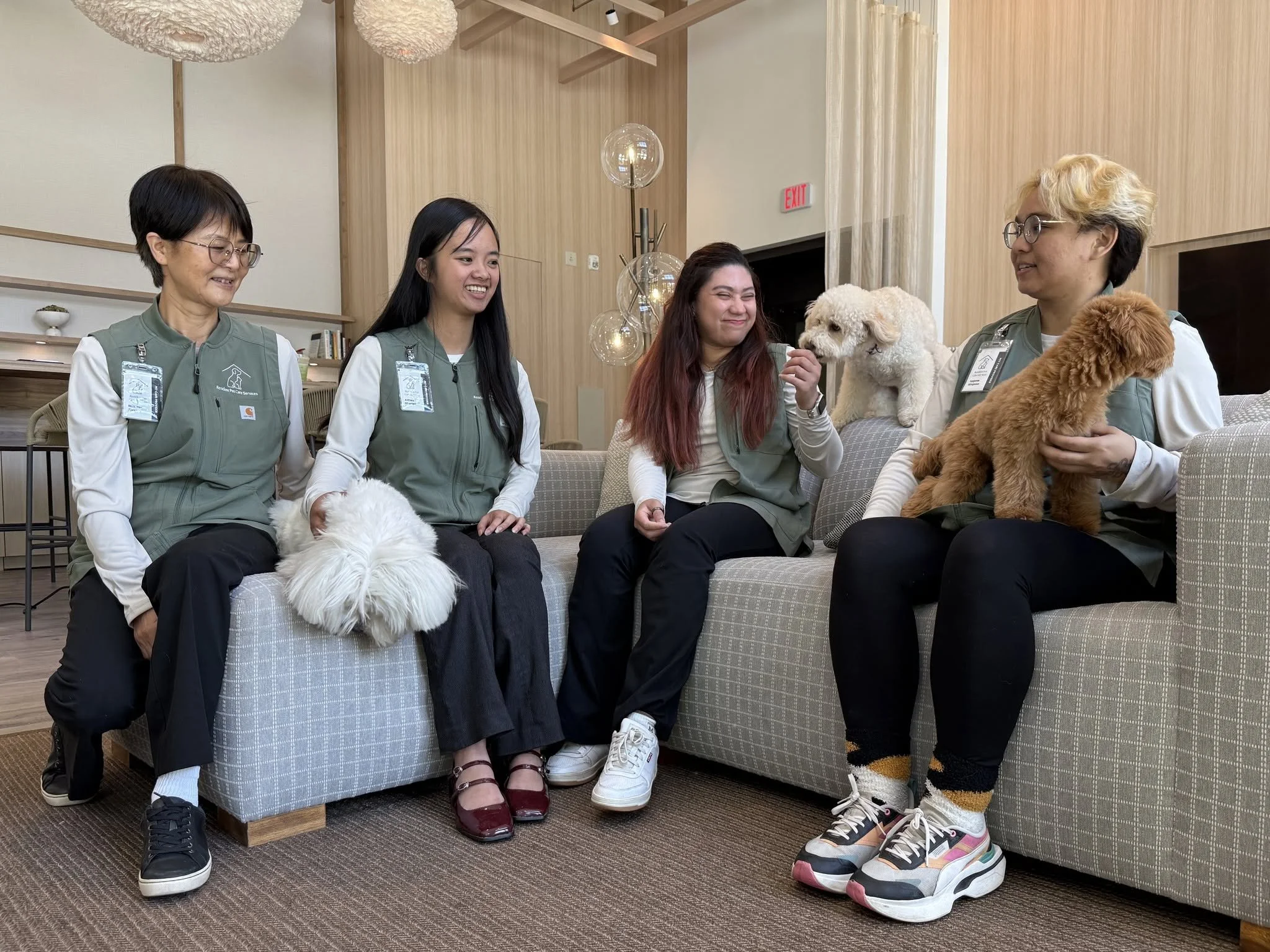 Resident Pet Care Services caregivers smiling with resident dogs at a pet-friendly senior living community in San Diego
