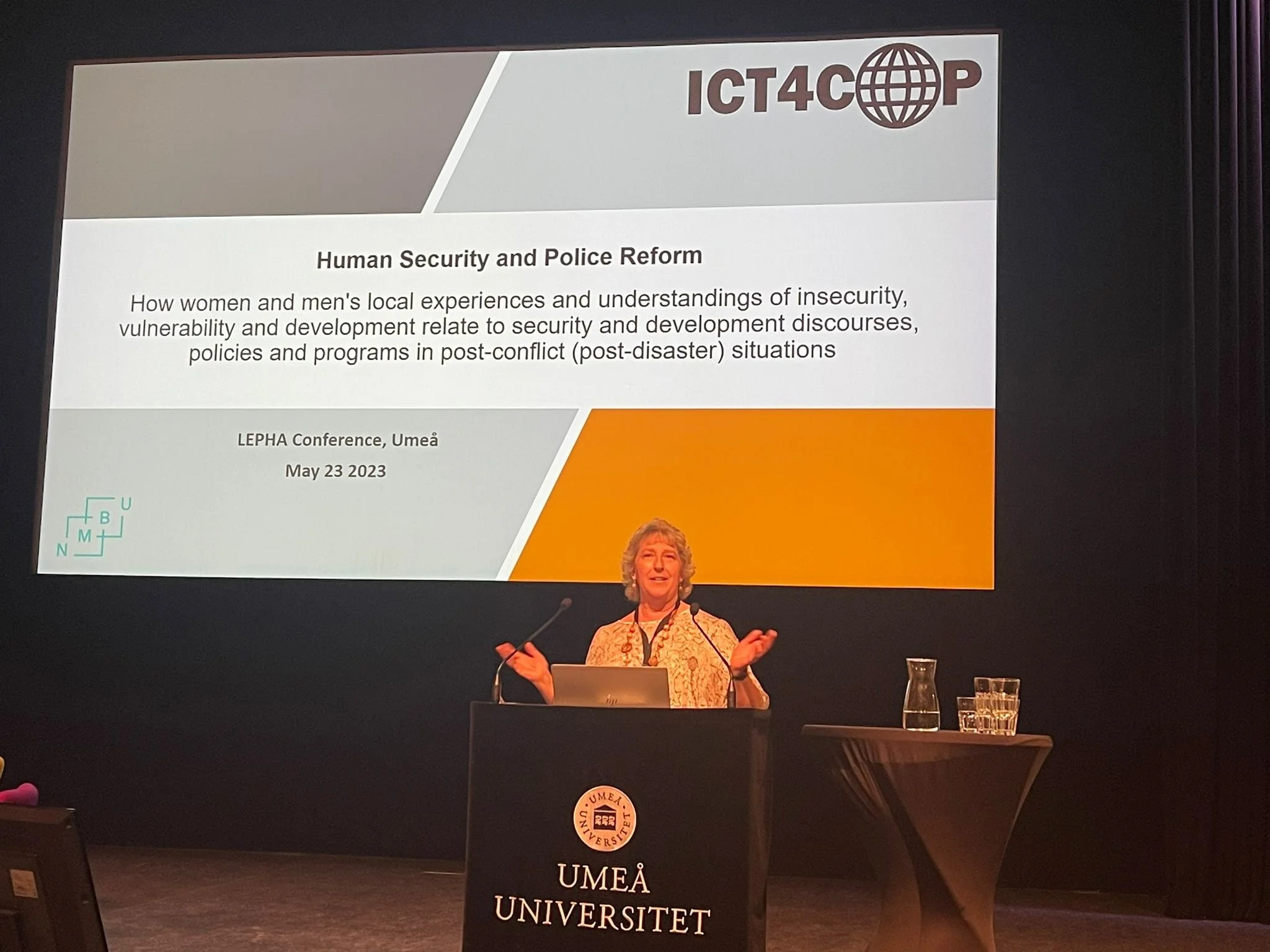 Ingrid Nyborg 'ICT4COP', 'Human Security and Police Reform,'  in Umeå, Sweden, on May 23, 2023. On the table in front of her, there are a microphone, a glass of water, and a laptop.