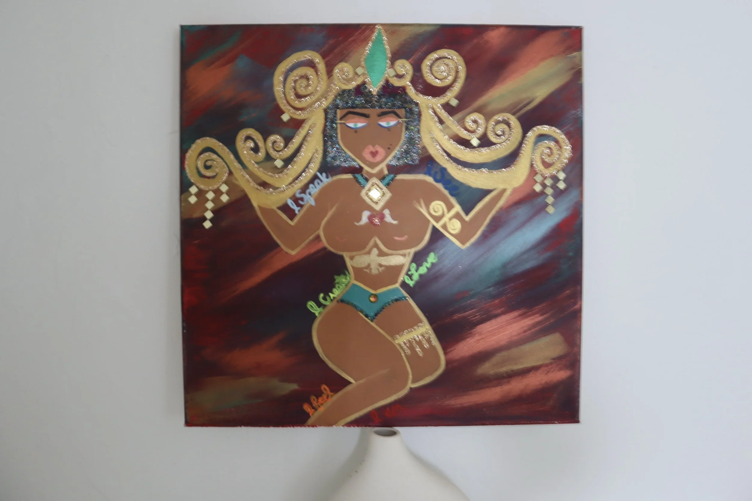 Egyptian Goddess Oracle  · 
Mixed media on canvas · 18 × 18 × 2 in   · 
2023  · 
A contemporary interpretation of feminine sovereignty inspired by ancient Egyptian symbolism. Metallic elements and layered textures evoke intuition, protection, and inn