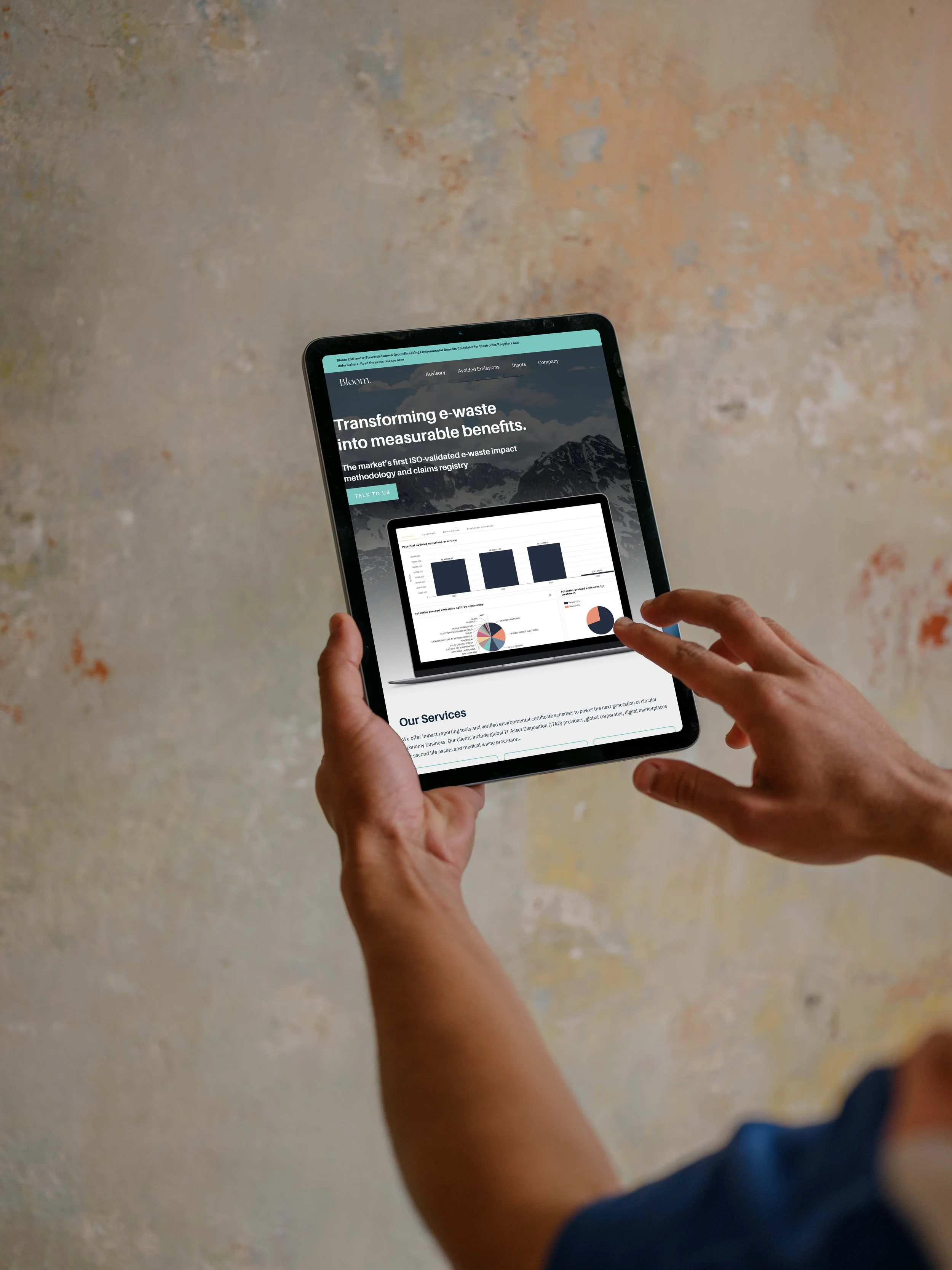 Person holding tablet displaying e-waste transformation service website