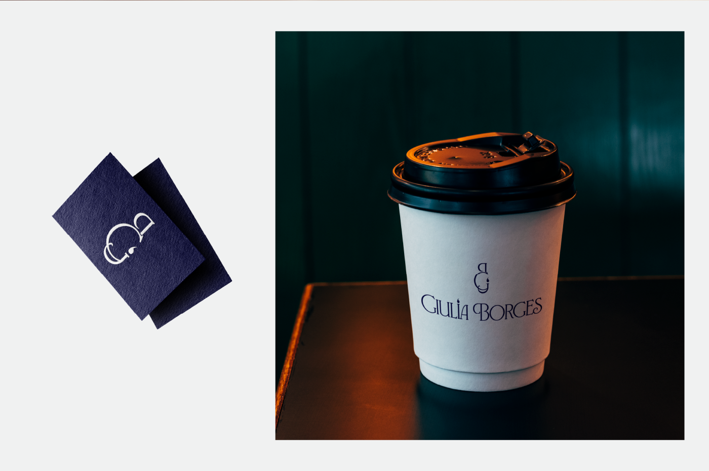A white coffee cup with a black lid, labeled "Giulia Borges," next to blue business cards with a white logo.