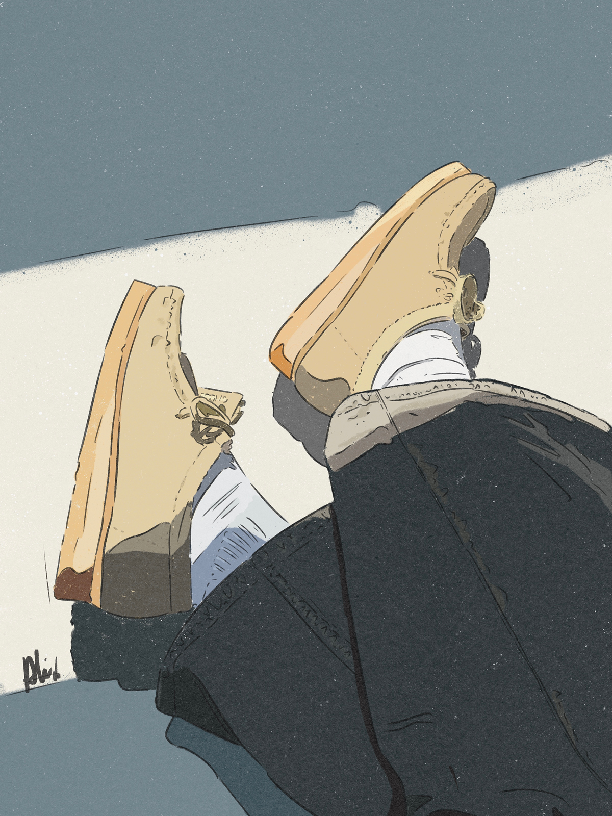 A pair of tan work boots are lying on a white and gray surface, viewed from a low angle.