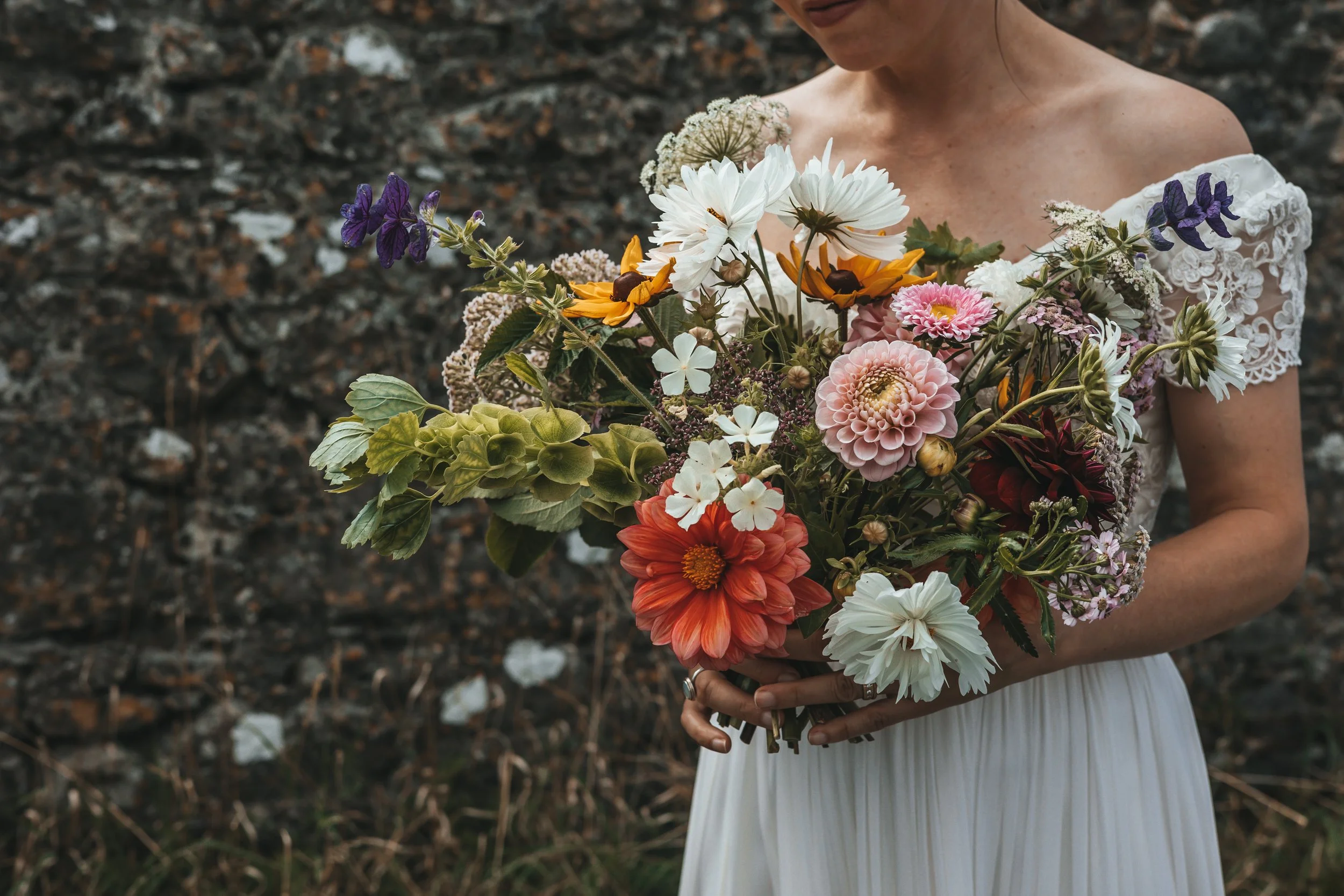 Bride holds a garden bouquet of flowers