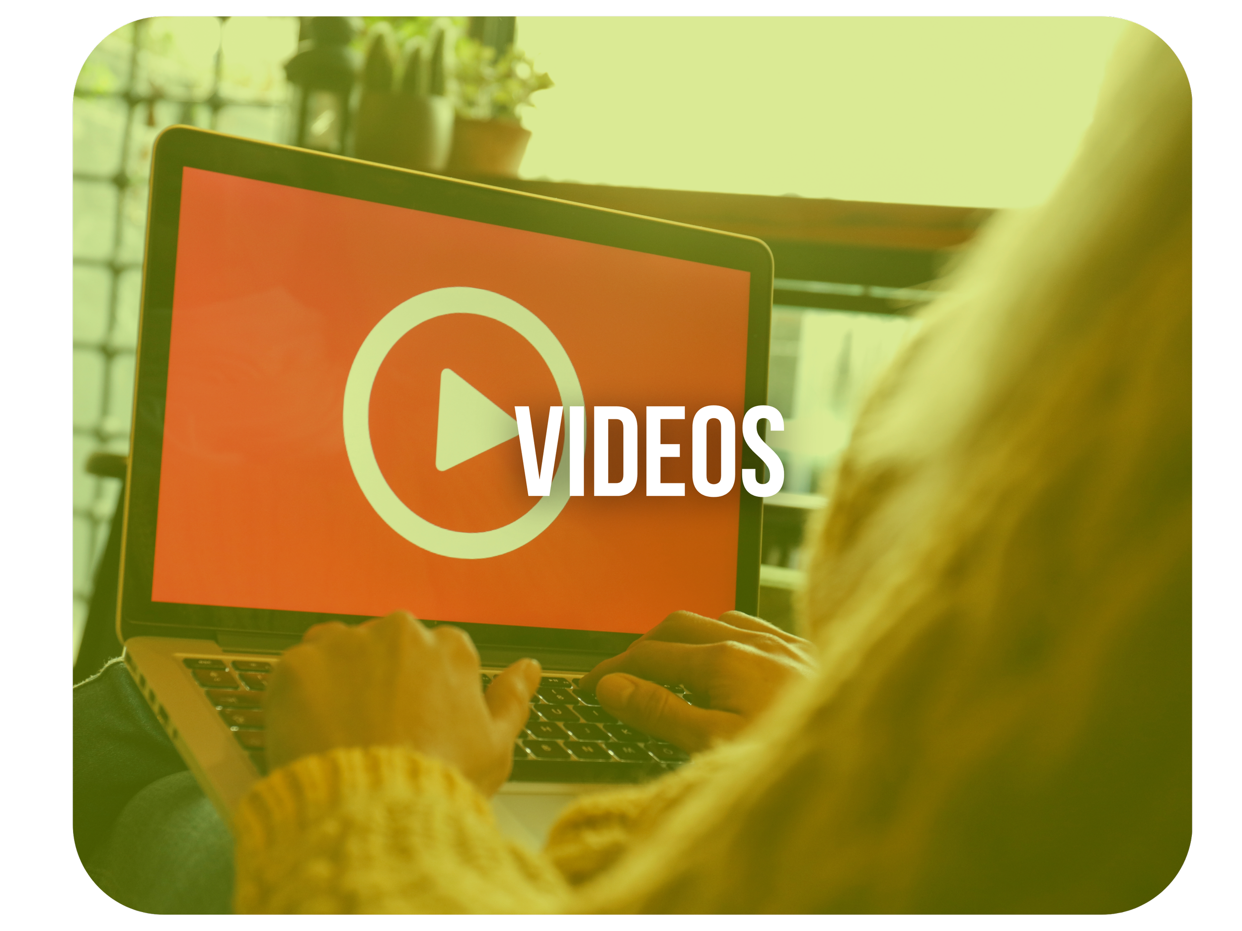 Person sitting at a desk using a laptop with a large play button icon on the screen and the word 'VIDEOS' overlaid on the image.