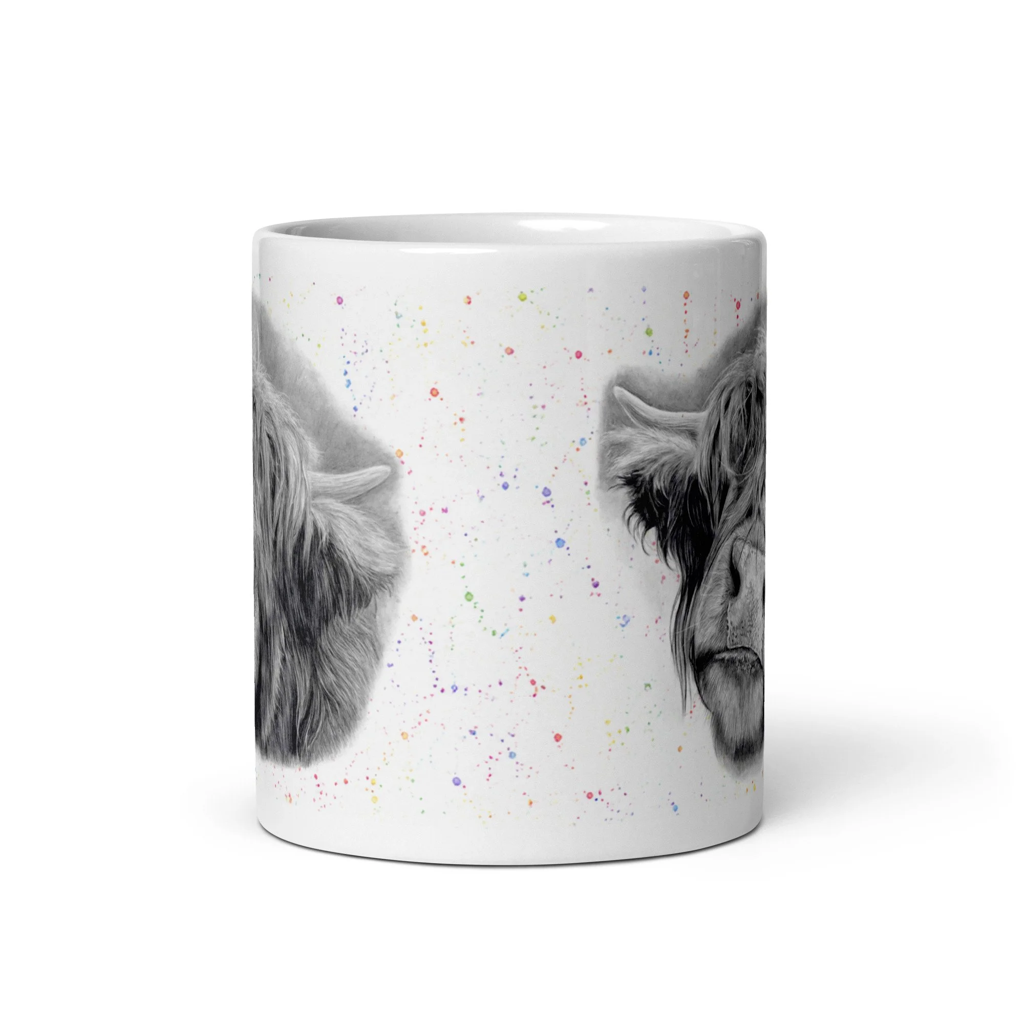 Angled view of a Highland Cow ceramic mug displaying detailed artwork by Matt Lloyd against a subtle colour fleck background on a glossy white mug.