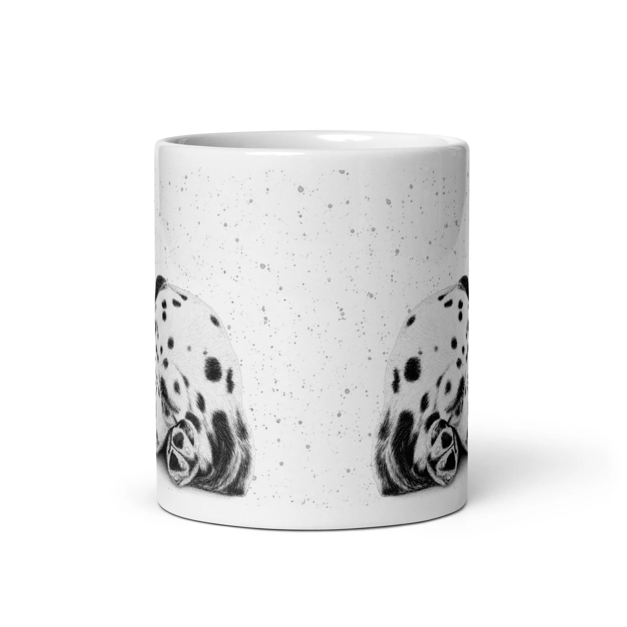 Angled view of a sleeping Dalmatian puppy mug displaying detailed artwork against a subtle grey fleck background on a glossy white mug.