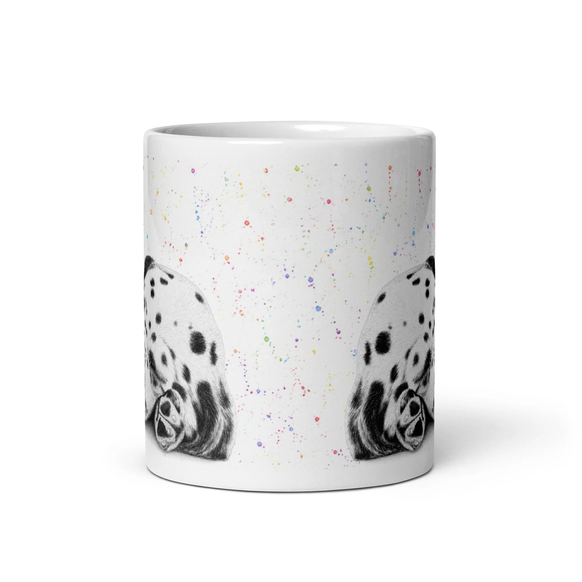 Angled view of a sleeping Dalmatian puppy mug displaying detailed artwork surrounded by vibrant colour flecks on a glossy white mug.