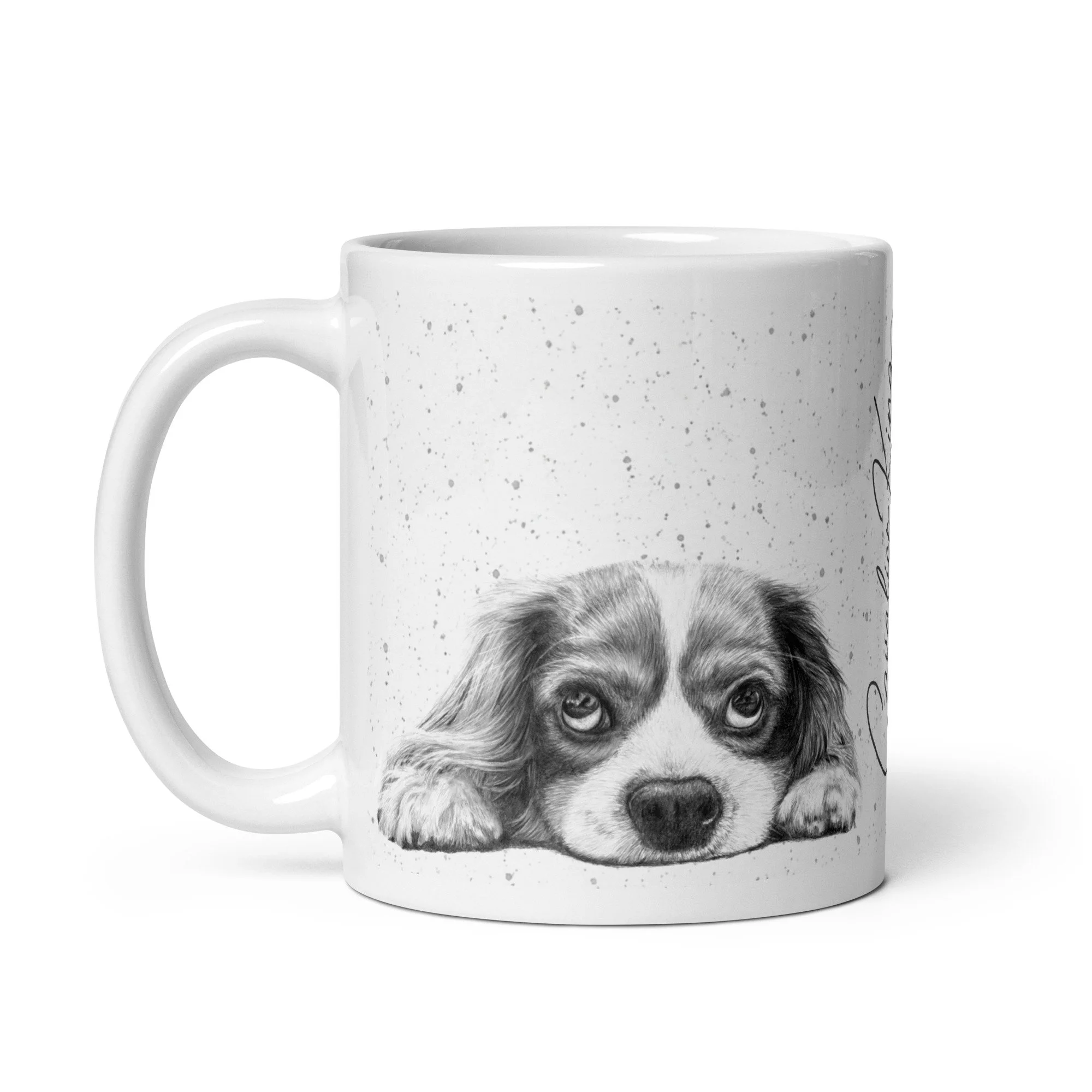 Ceramic mug displaying a Cavalier King Charles Spaniel portrait with grey speckled background and signature font.